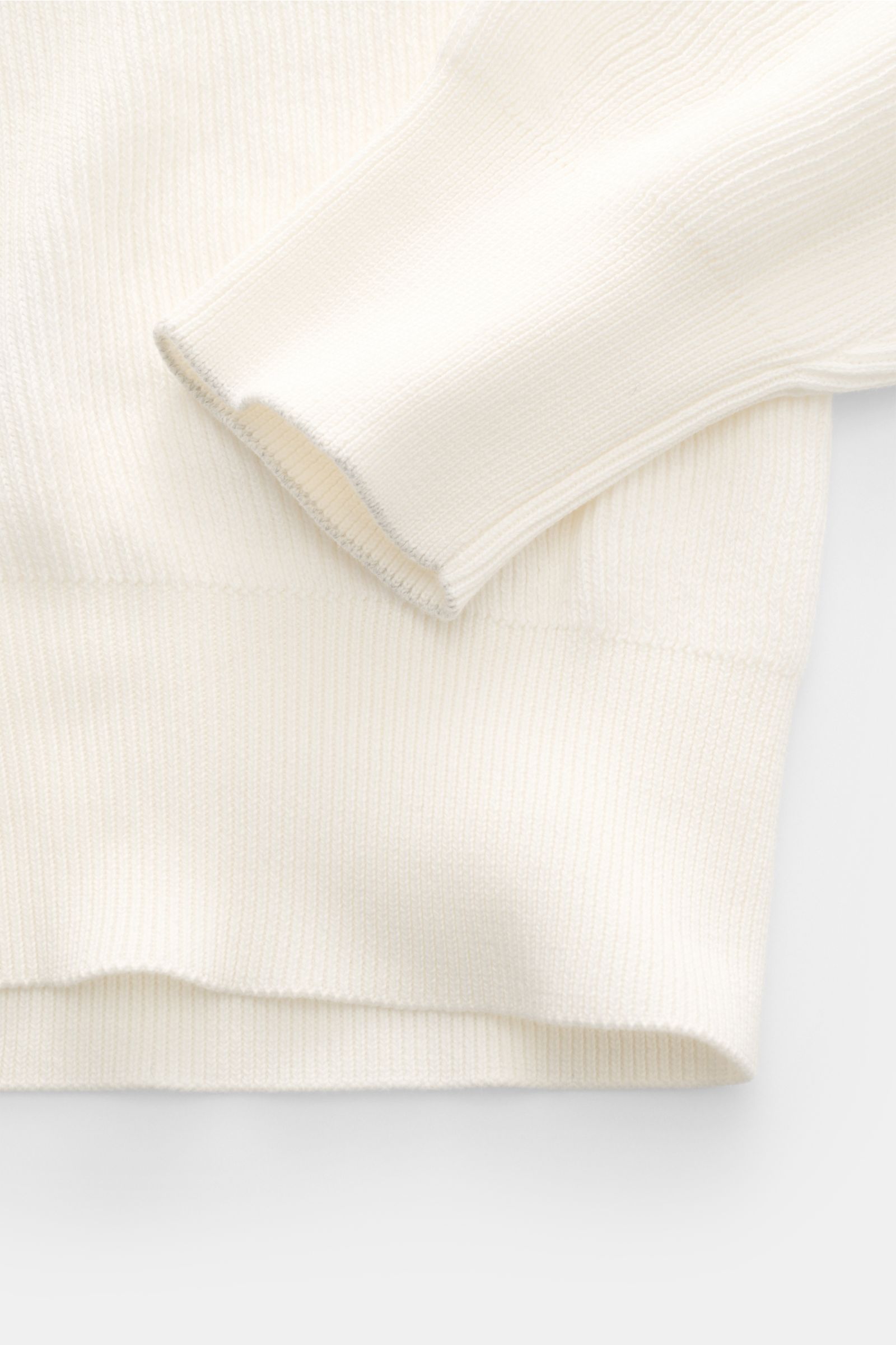 Close-up of the off-white Brunello Cucinelli Cardigan photographed from above, showing the soft pure cotton brioche knit fabric and ribbed cuffs.

Luxury for the office and your downtime: This cardigan in fine brioche knit in soft cotton enhanced with 