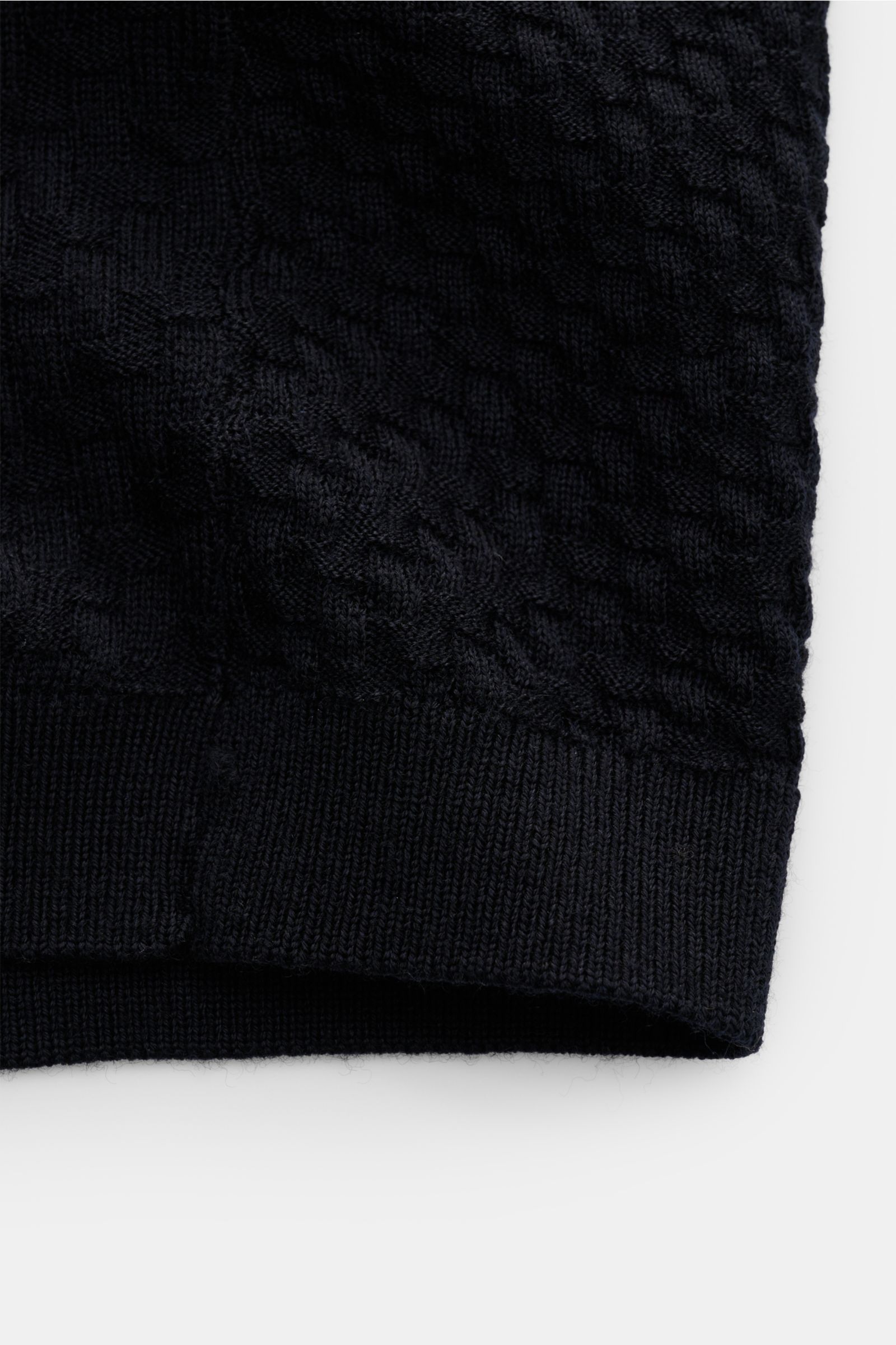 Close-up front view of textured knit Emporio Armani Short sleeve jumper navy showing ribbed hem and woven label detail.

Description: 
Versatile companion: This lightweight short sleeve jumper in pure virgin wool by EMPORIO ARMANI has a subtle textured