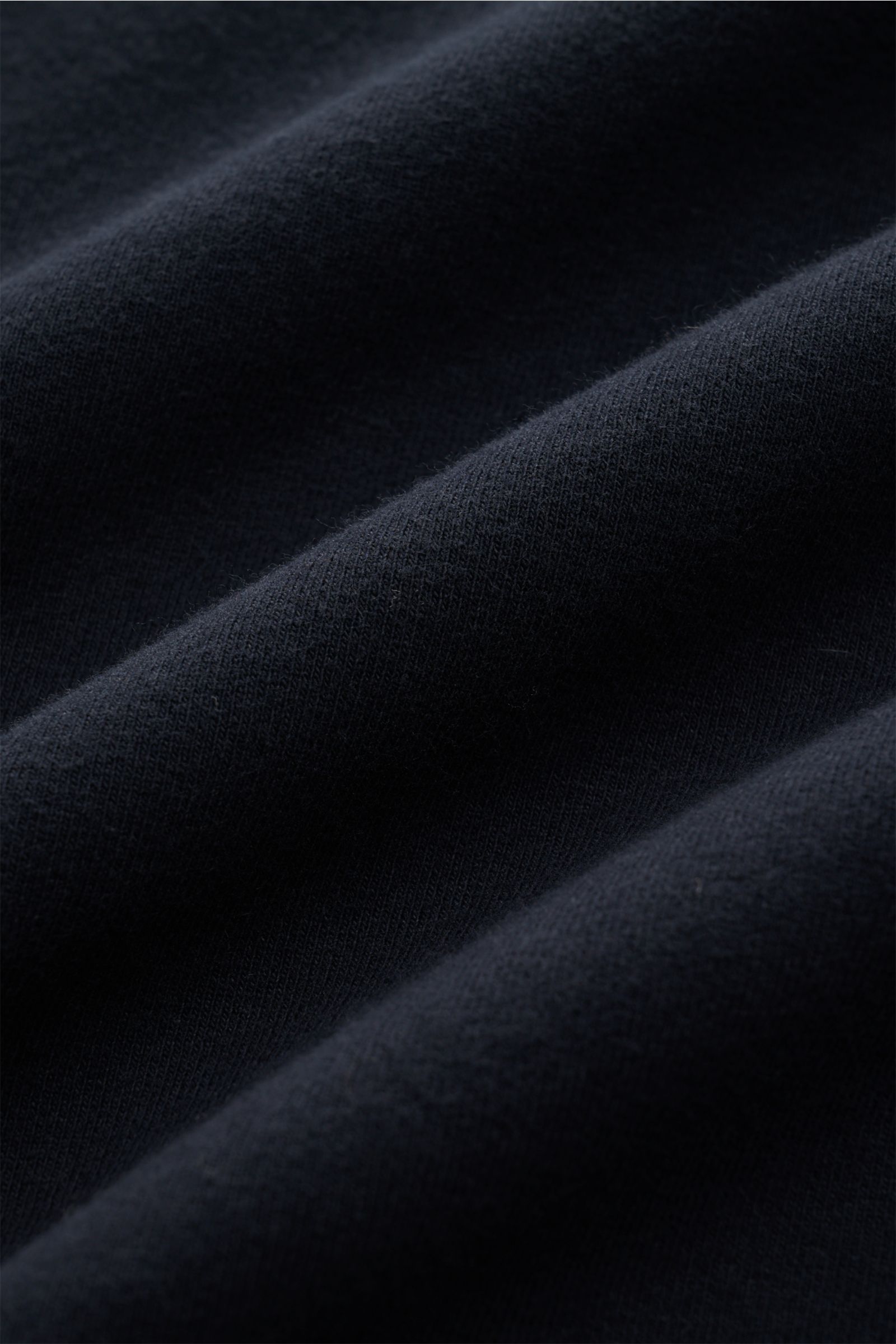 Close-up front view of navy fabric texture from the Stone Island Rundhals-Sweatshirt 'Ghost Piece' navy, soft inner cotton.

Description: Softer, innen angerauter Baumwoll-Sweat bildet die Basis für dieses legere Sweatshirt, welches STONE ISLAND als Te