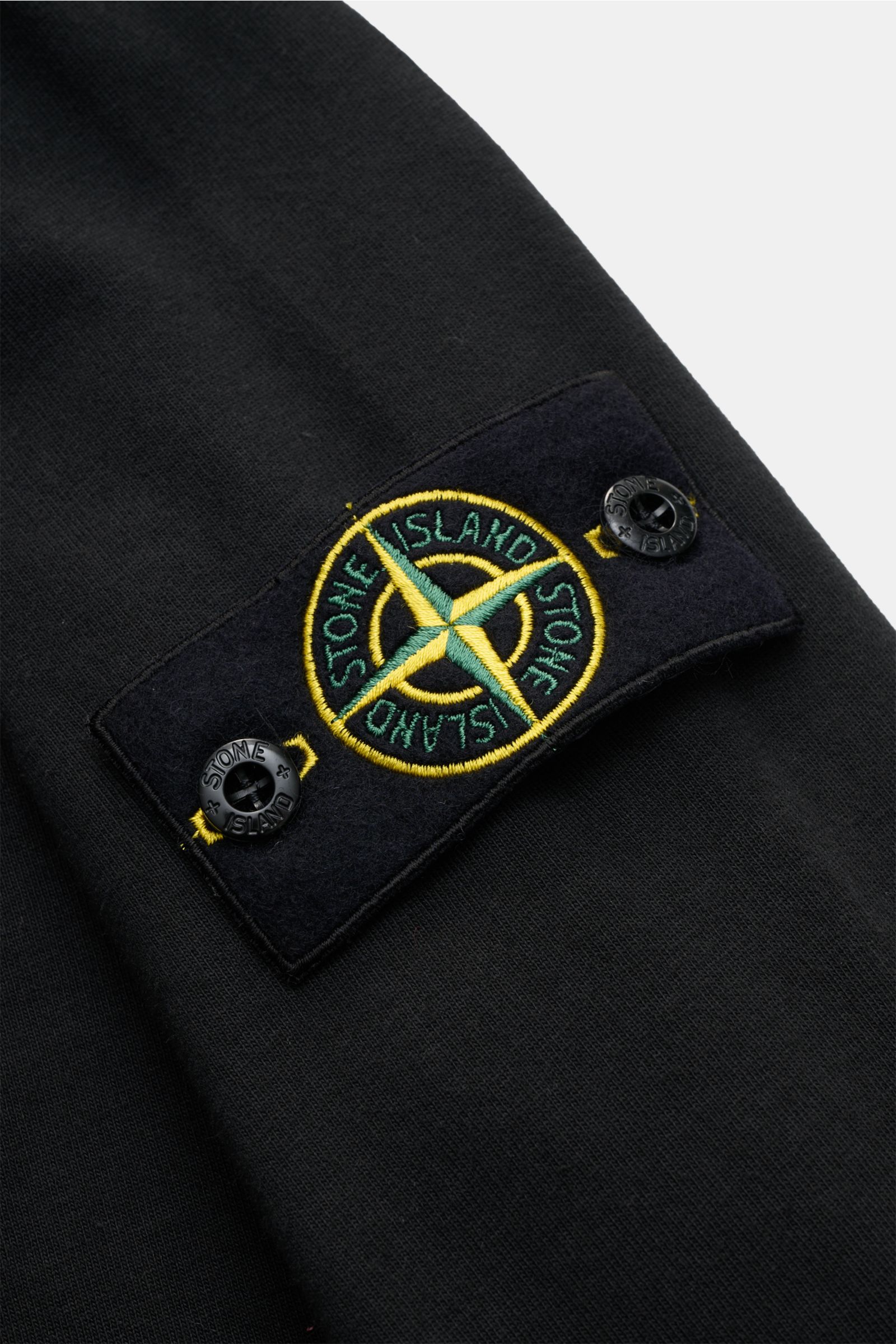 Close-up of the Stone Island Long sleeve black showing the compass badge on the sleeve, photographed from a top-down angle.

Description: With this crew neck long sleeve in heavy cotton jersey with compass badge on the sleeve, STONE ISLAND brings us a 