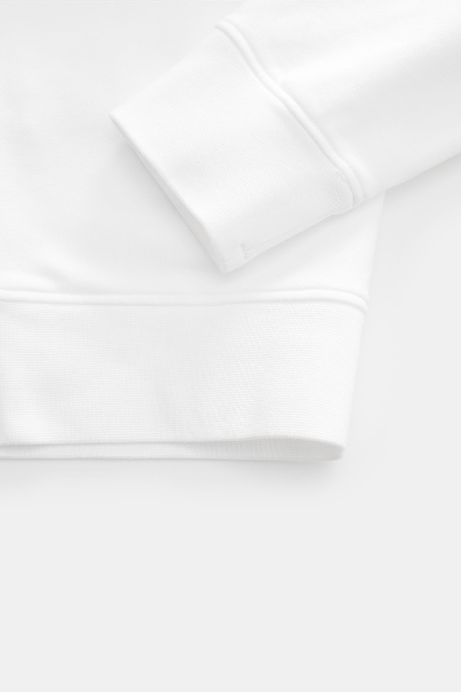 Close-up of the sleeve and hem of the Stone Island Rundhals-Sweatshirt 'Basic Sweat' weiß, showing ribbed cuffs and soft cotton fabric from above.

Zeitloses Basic Piece: Das sportive Sweatshirt von STONE ISLAND wird zur idealen Grundlage legerer Freiz