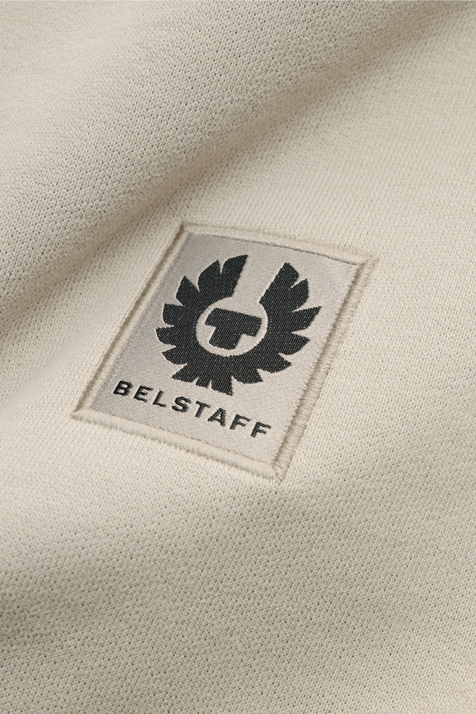 Close-up front detail of Belstaff Sweatshirt beige showing tonal woven label with black logo on soft, pure cotton fabric.

This sweatshirt by BELSTAFF creates modern accents with artistic decorative stitching, the characteristic V-stitch and a tonal wo