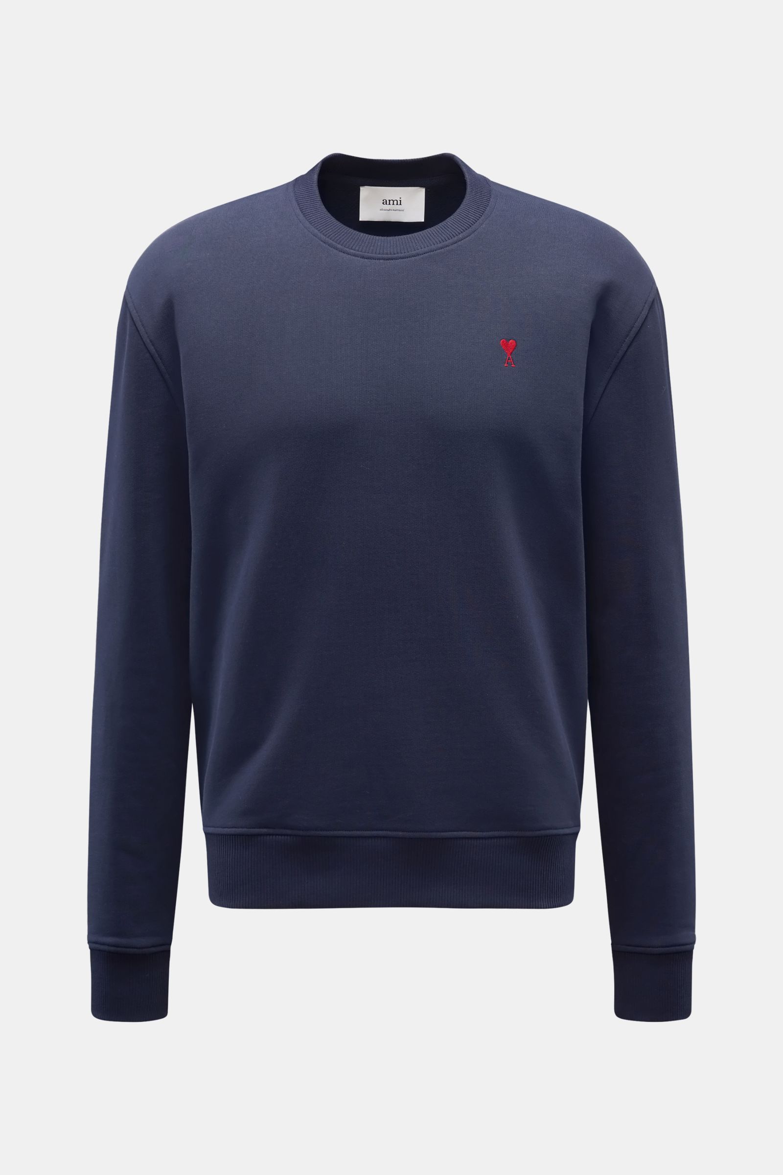 Front view of Ami Paris Crew neck sweatshirt navy in pure cotton, featuring soft feel, regular fit, crew neck, red logo stitching on chest, and flexible ribbed bands. Comfortable basic: The AMI PARIS sweatshirt in pure cotton is the ideal companion for sp