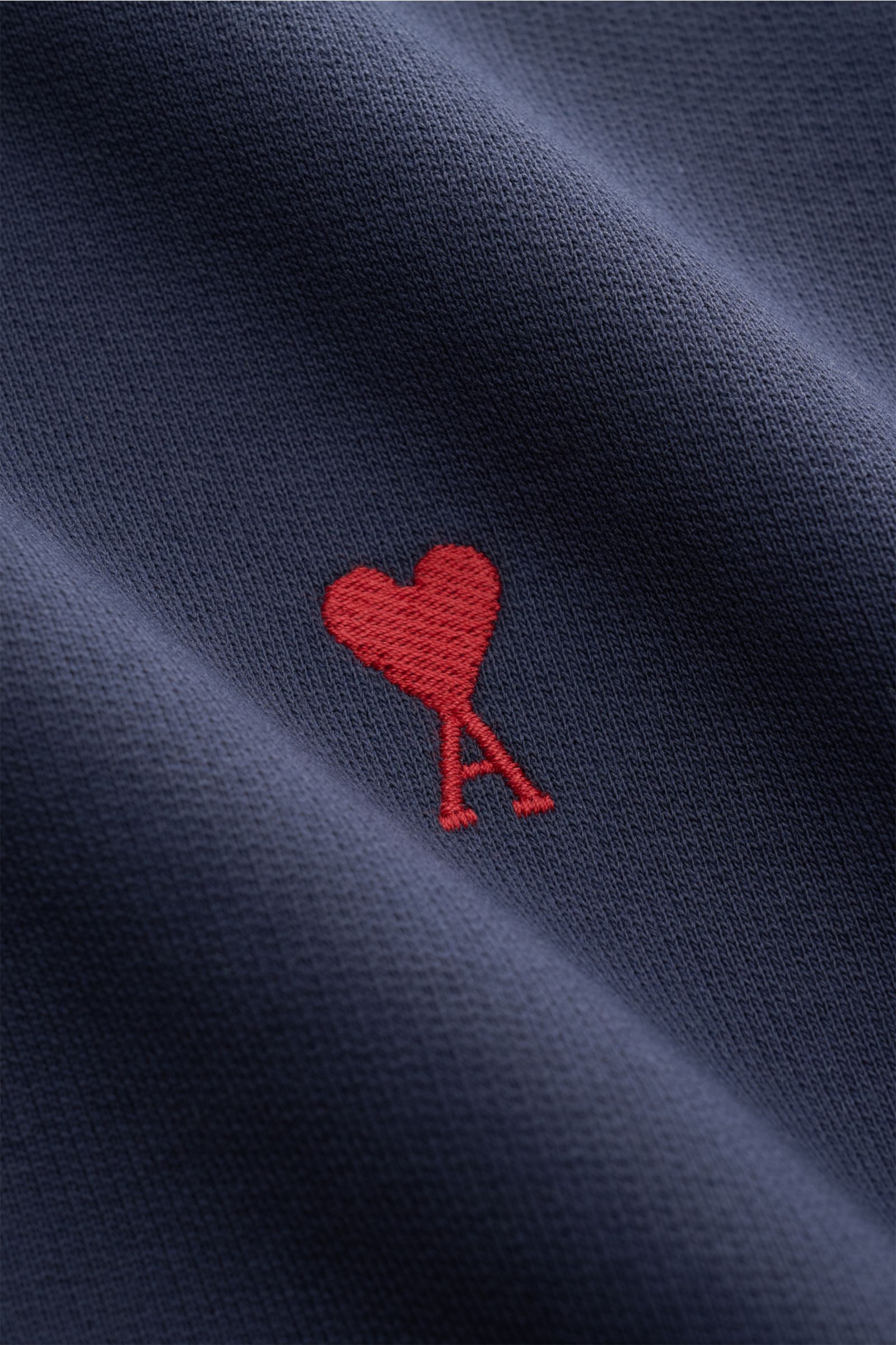 Close-up front view of the Ami Paris Crew neck sweatshirt navy showing red heart and 'A' logo stitching on soft pure cotton fabric.

Comfortable basic: The AMI PARIS sweatshirt in pure cotton is the ideal companion for sporty looks.

Sweat 