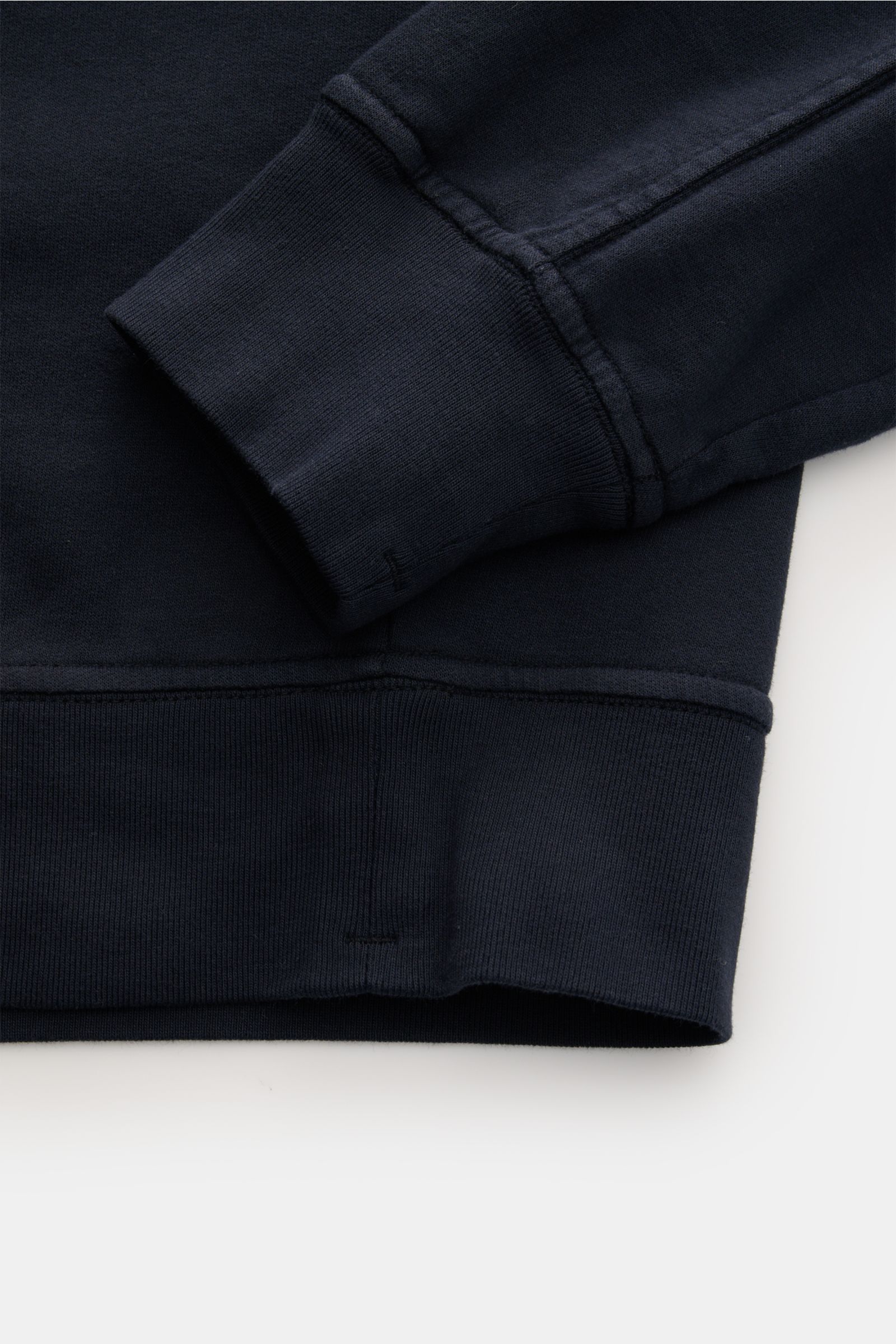 Close-up front view of the navy sleeve cuff and hem of the C.P. Company Sweatshirt navy, showing ribbed flexible cuffs and stitching details 