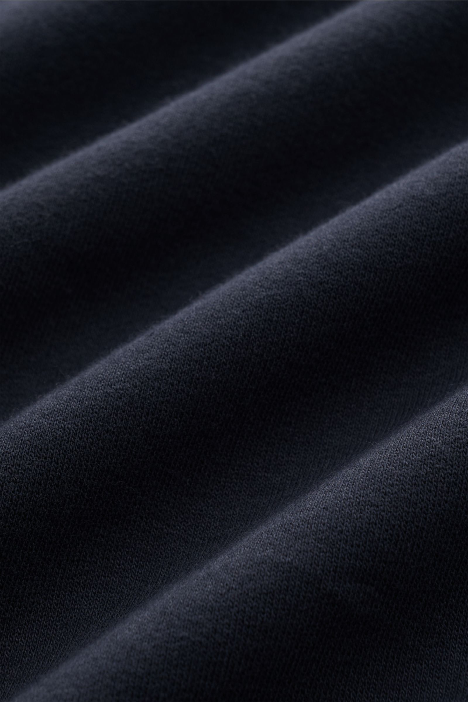 Close-up front view of the C.P. Company Sweatshirt navy showing soft, lightweight pure cotton fabric with garment-dyed texture and fine knit details. 