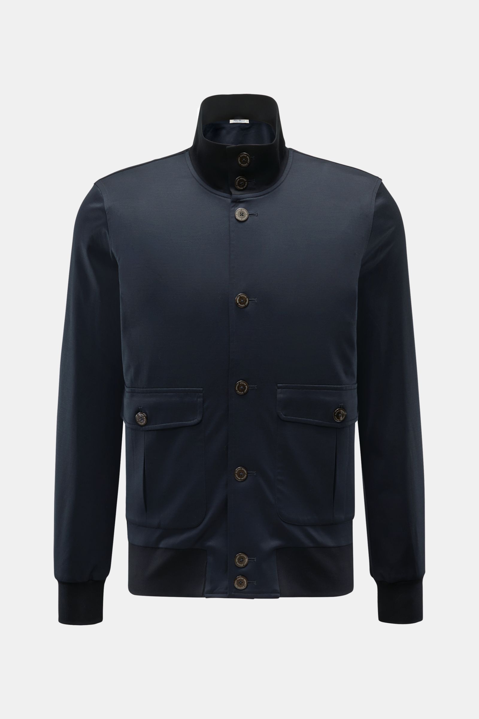 Front view of Stefan Brandt Jersey blouson 'Jeff' navy, a slim fit jacket with eight-button placket, standing collar, button flap front pockets, elasticated bands, and one inside pocket made from smooth pure Pima cotton jersey.

Exception material and 