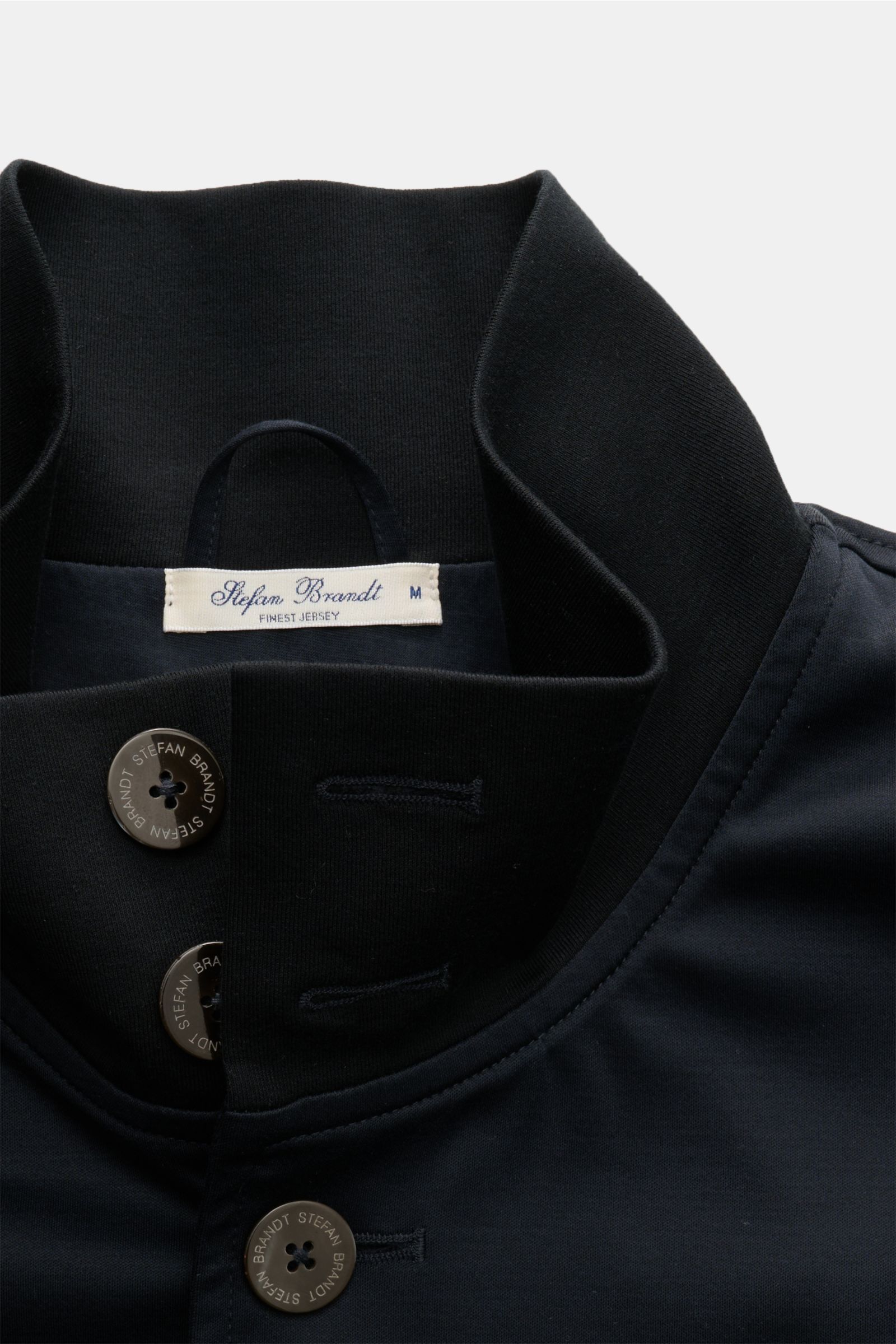 Close-up front view of the Stefan Brandt Jersey blouson 'Jeff' navy, featuring a high-closing standing collar and eight-button placket. Exception material and design: With the blouson 'Jeff' STEFAN BRANDT presents a sporty statement piece in the brand’s s