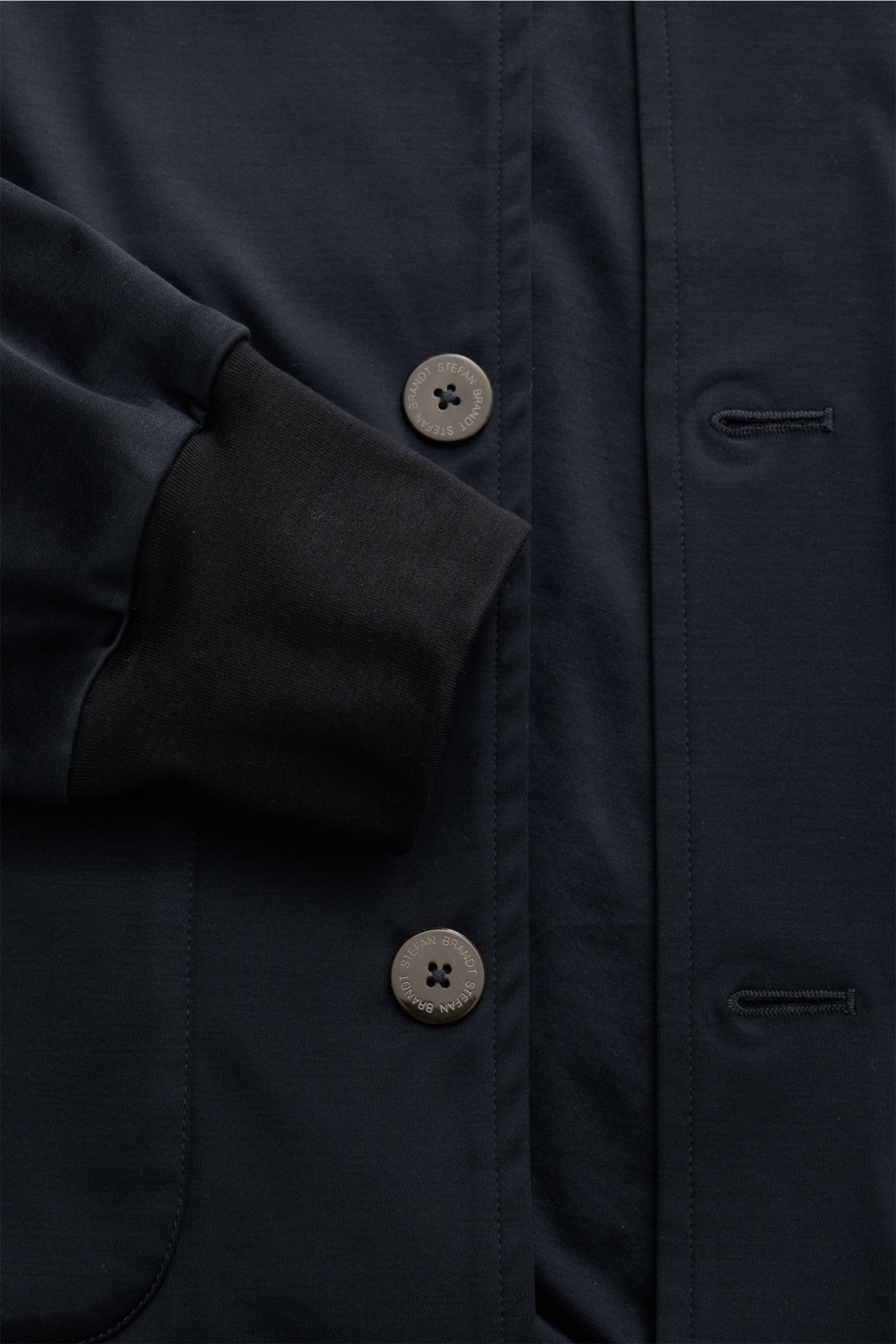 Close-up front view of Stefan Brandt Jersey blouson 'Jeff' navy showing the eight-button placket, smooth navy jersey fabric, elasticated cuff, and button flap pocket details. Exception material and design: With the blouson 'Jeff' STEFAN BRANDT presents a 