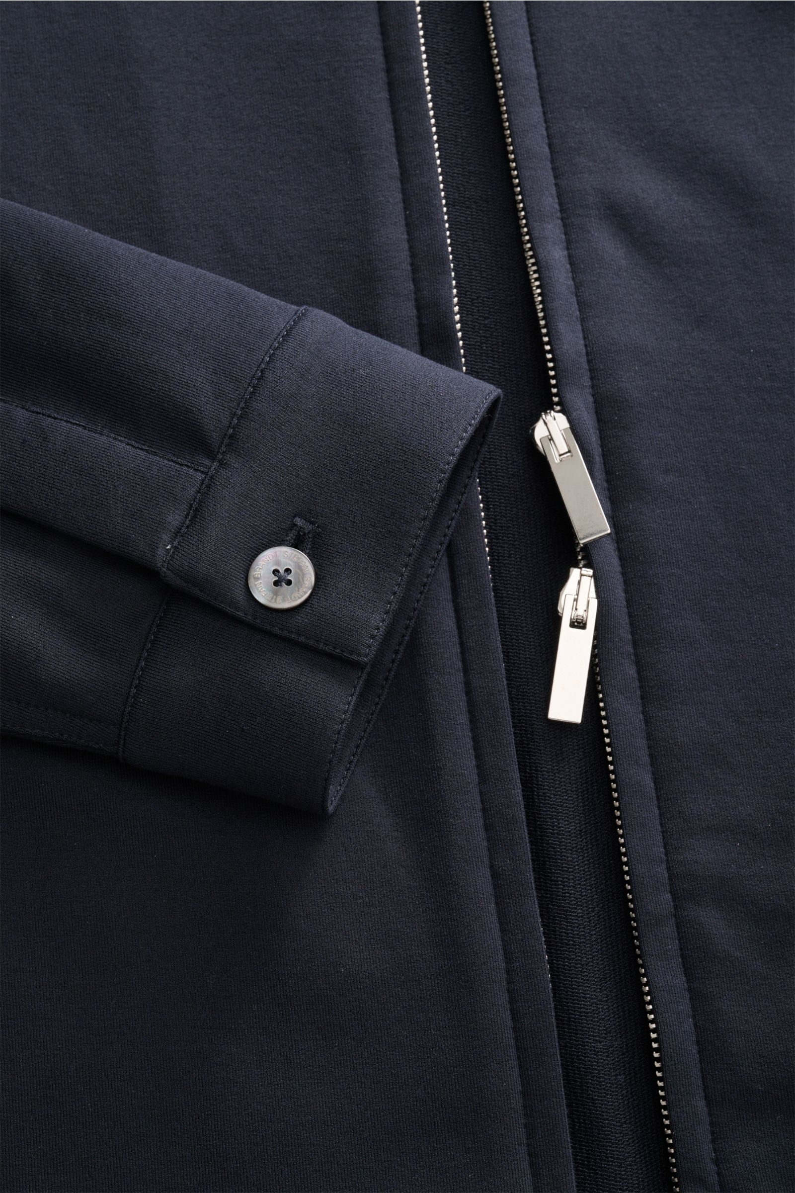 Close-up front view of the Stefan Brandt Sweatjacke 'Alek' navy, showing sleeve cuff with button and silver two-way zipper, made of soft pima cotton with stretch for comfort.