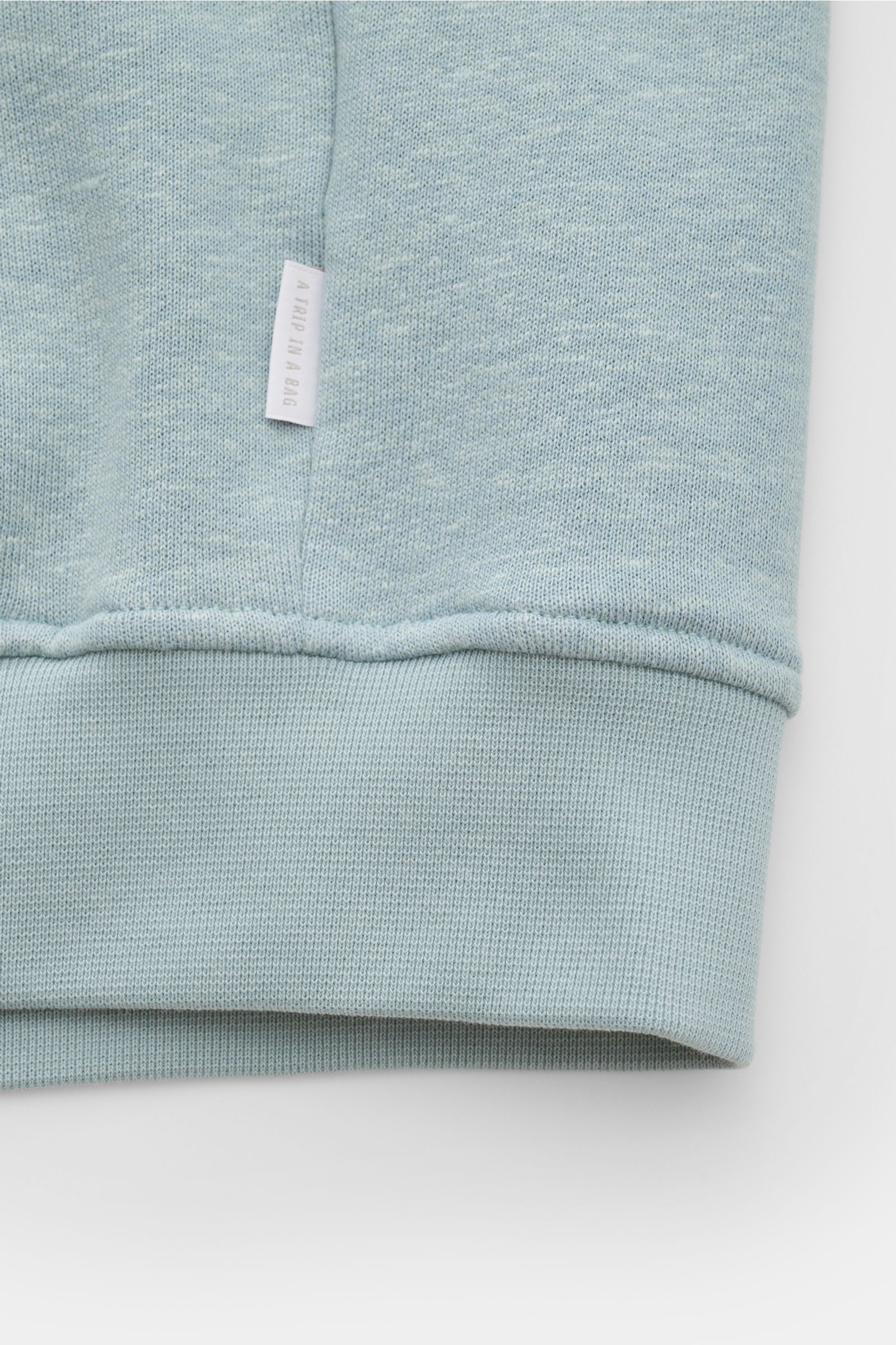 04651/ A trip in a bag Sweatjacke 'CL Bomber' rauchblau im Nahaufnahme-Detail mit flexiblem Rippbündchen und kleinem Weblabel, Bio-Baumwoll-Leinen-Mix, garment-dyed, Oversized Fit.