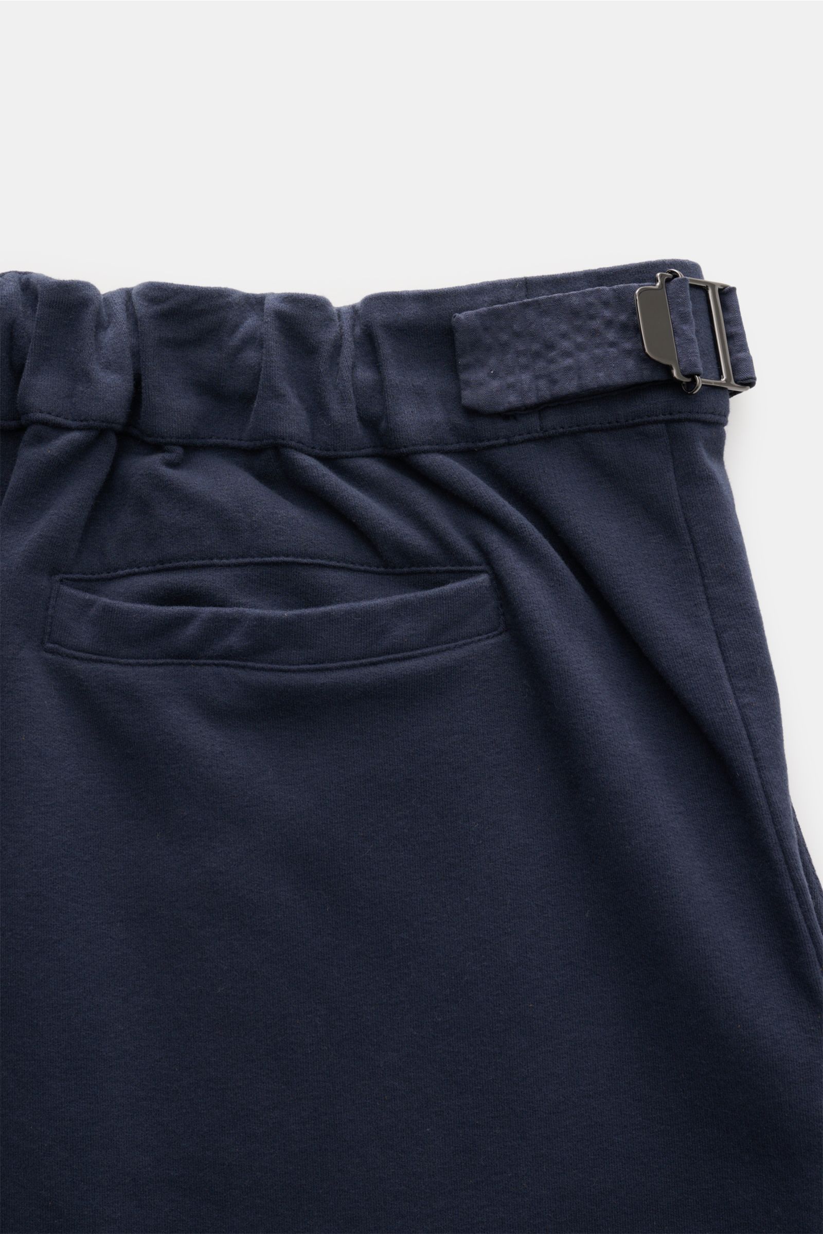 Close-up rear view of 04651/ A trip in a bag Cotton trousers navy, showing soft cotton jersey fabric, partially elasticated waistband with side adjuster, and a hip pocket with fixed hem turn-up. Enjoy maximum comfort in your everyday life: These comfortab