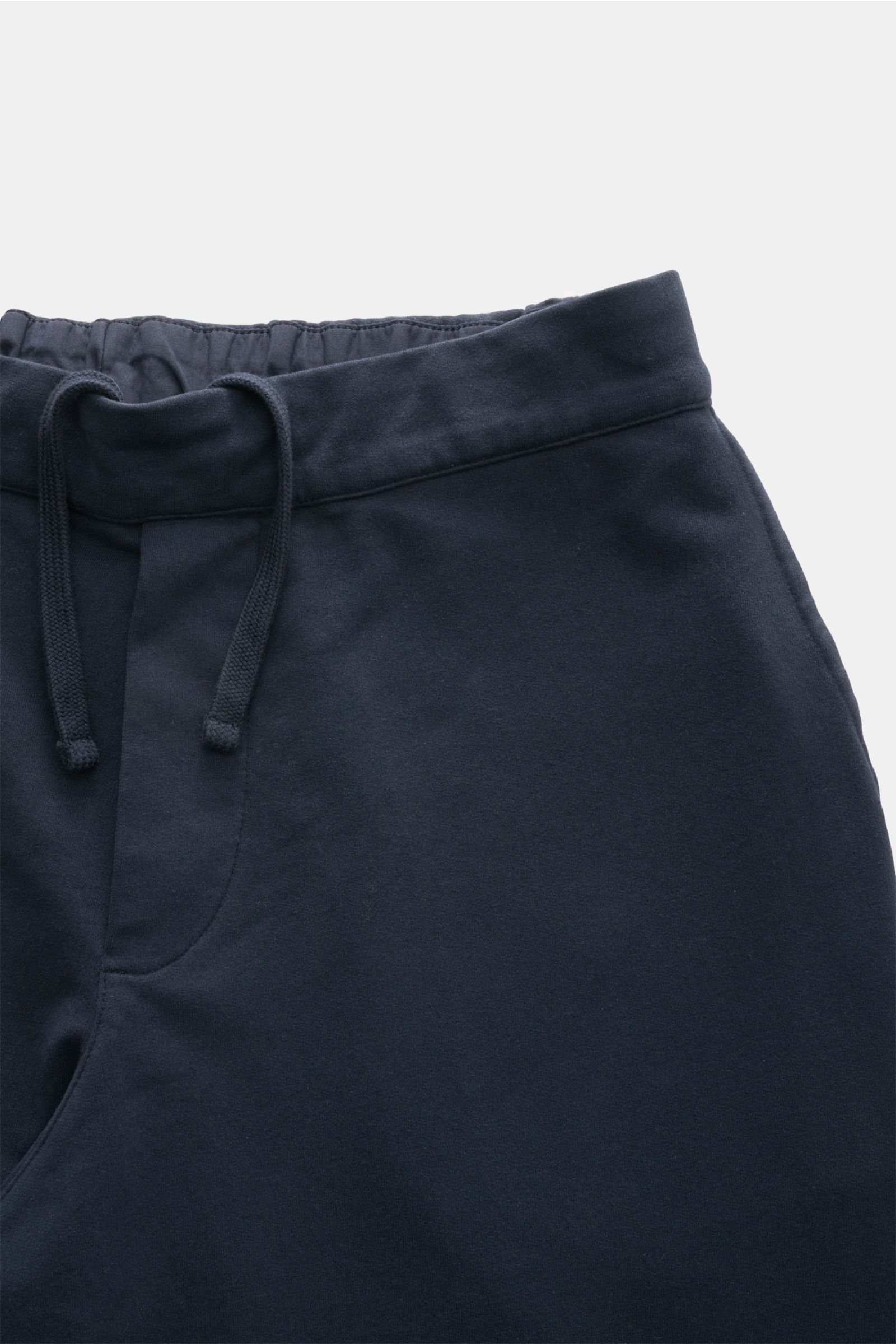 Close-up front view of navy 04651/ A trip in a bag Jogger pants 'If' featuring a partially elasticated waistband with drawstring and soft cotton jersey fabric. 

Comfort meets style: These jogger pants in soft cotton jersey by 04651/ A TRIP IN A BAG en