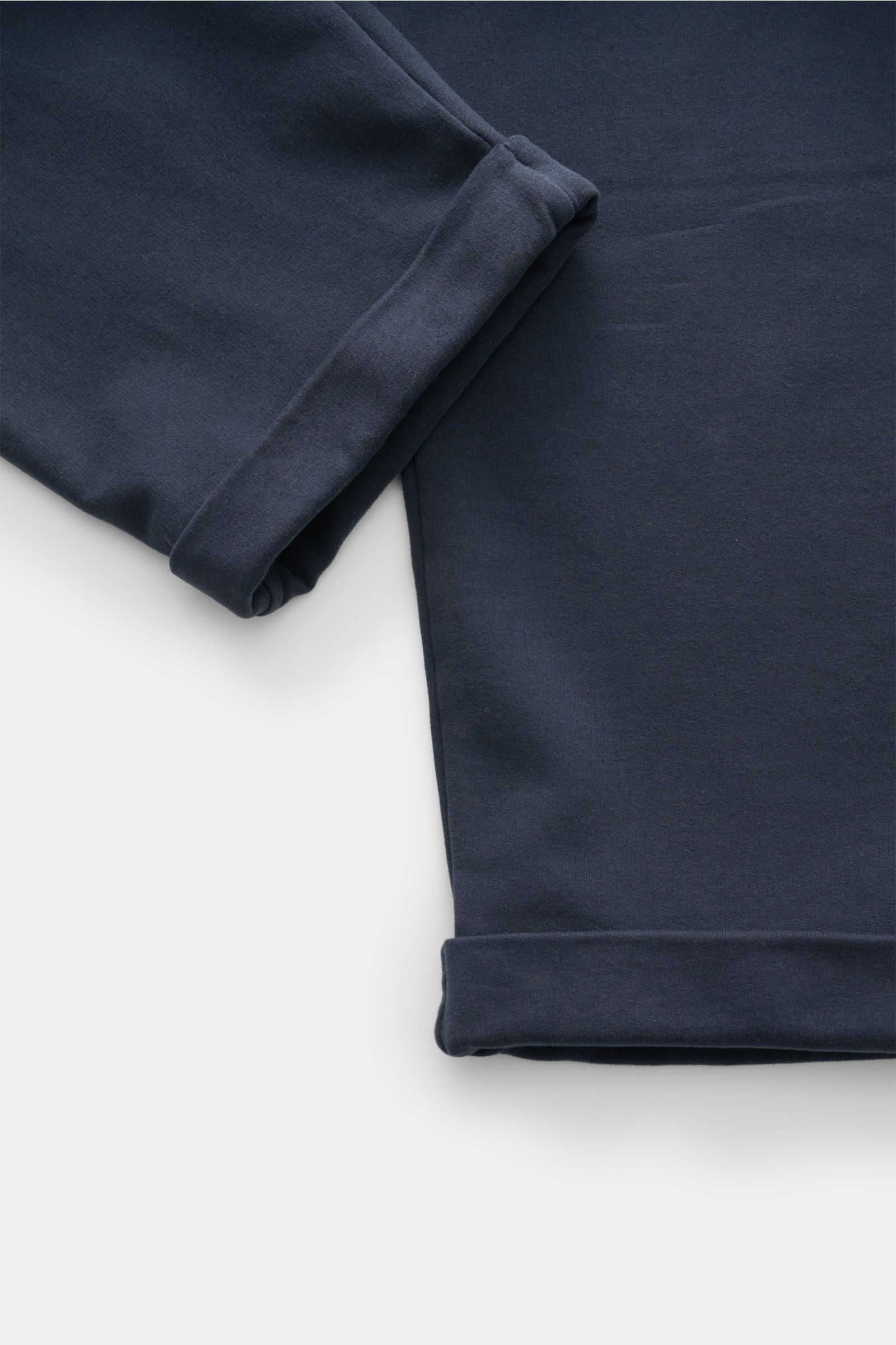 Close-up top view of 04651/ A trip in a bag Jogger pants 'If' navy showing soft cotton jersey fabric with tapered ankle cuffs.

Description: Comfort meets style: These jogger pants in soft cotton jersey by 04651/ A TRIP IN A BAG enhance relaxed looks w