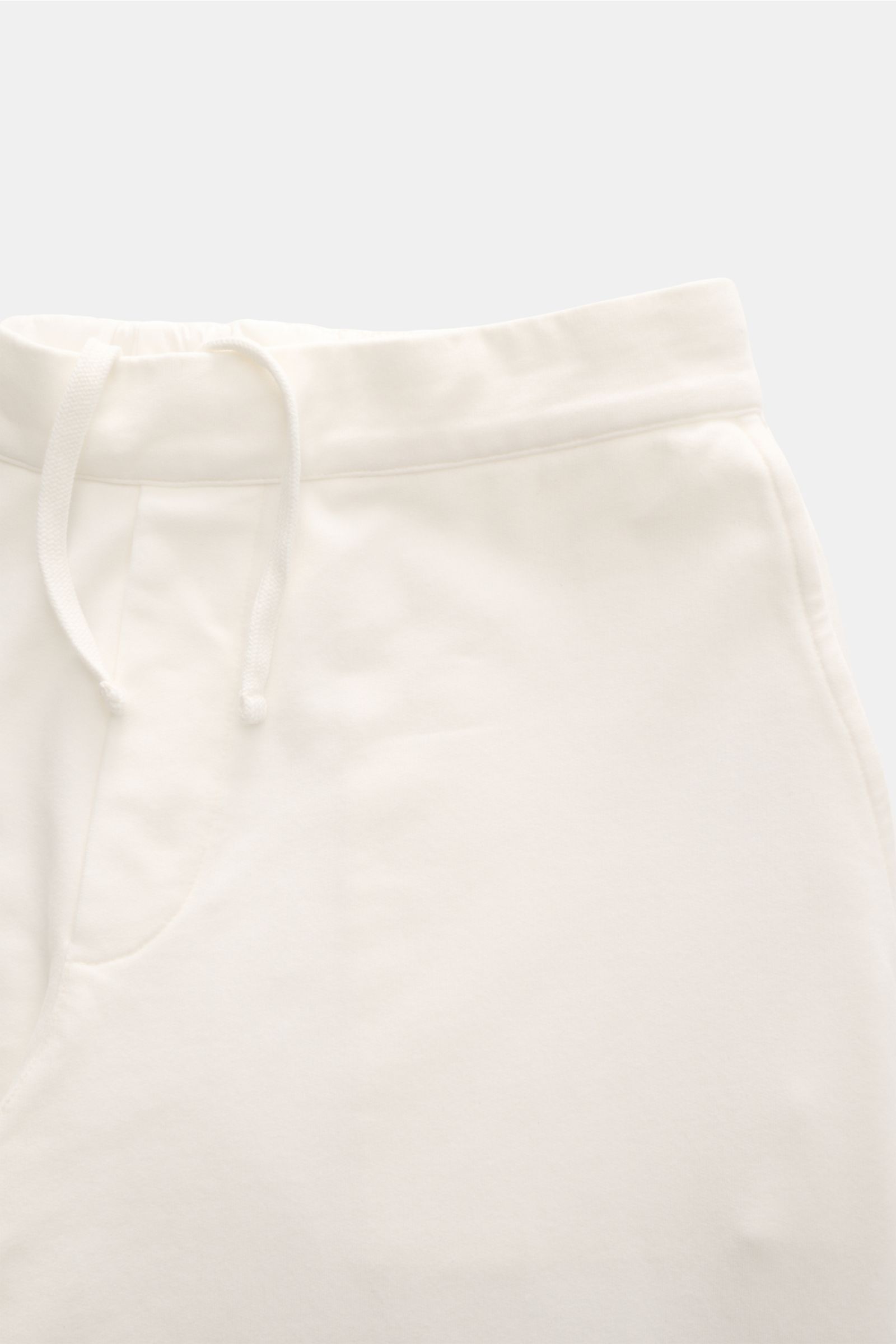 Close-up front view of 04651/ A trip in a bag Jogger pants 'If' off-white, showing soft cotton jersey, drawstring waist, and French pocket. Comfort meets style: These jogger pants in soft cotton jersey by 04651/ A TRIP IN A BAG enhance relaxed looks with 
