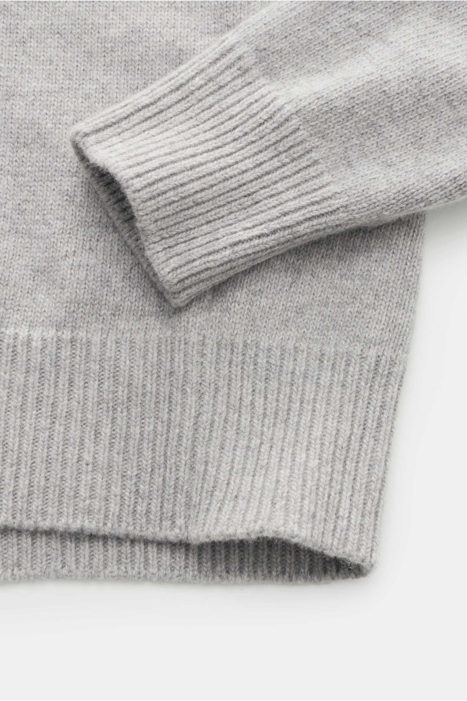 Close-up front view of Stone Island Half-zip jumper 'Lambswool' light grey, showing ribbed cuffs and hem in a soft wool blend knitwear. A stylish essential for the colder months: This timeless half-zip jumper by STONE ISLAND with zip and embossed buttons 