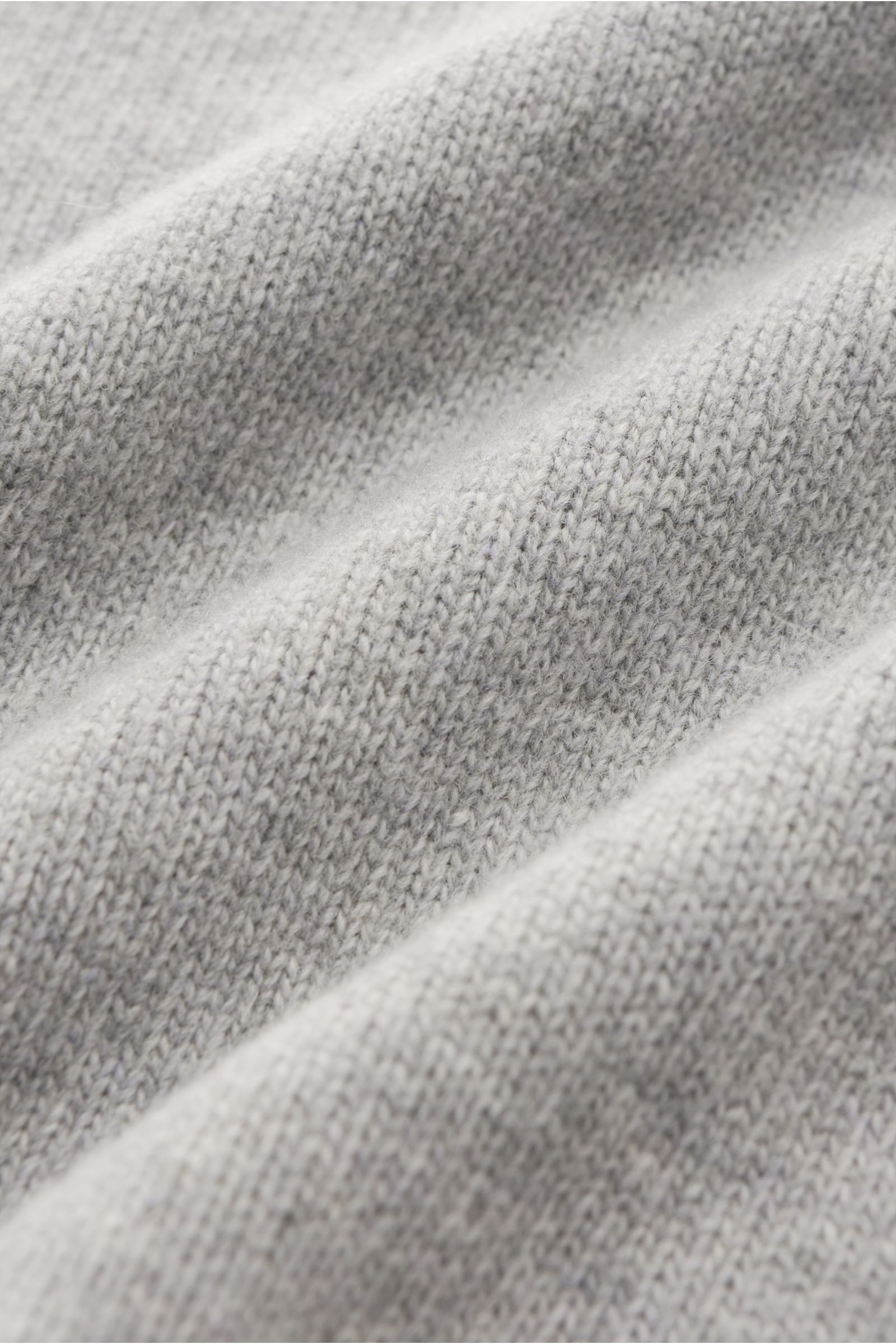Close-up front view of Stone Island Half-zip jumper 'Lambswool' light grey showing soft wool blend knitwear texture, medium-fine knit with elasticated ribbed bands.

A stylish essential for the colder months: This timeless half-zip jumper by STONE ISLA