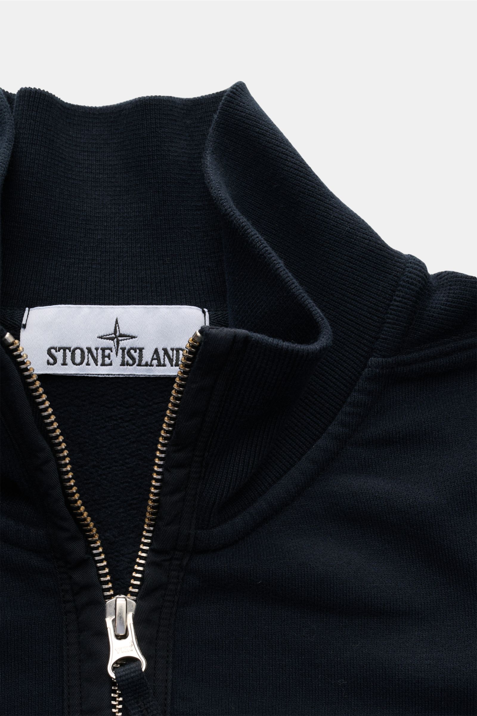 Close-up front view of Stone Island Sweat half-zip jumper navy showing rib knit collar, silver zipper, and fabric texture.

Create sporty looks in the colder months: This casual half-zip jumper made of soft sweat fabric by STONE ISLAND with a zip on th