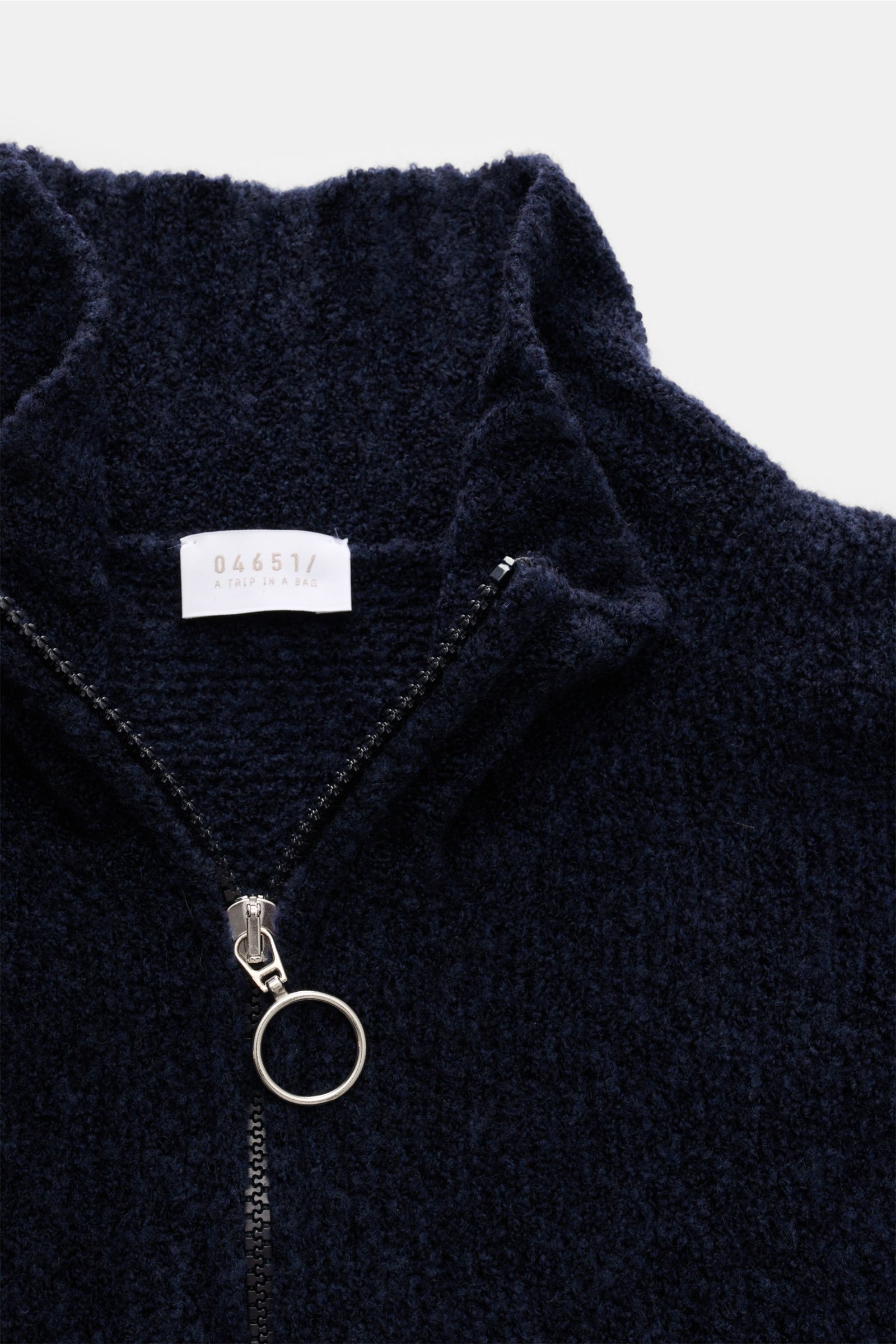 Close-up front view of the navy 04651/ A trip in a bag Half-zip jumper 'Grainy' navy showing high rib knit collar with zip, blend of wool and microfibre, soft feel, bouclé knit, medium-fine knit, regular fit, and wide ribbed bands.