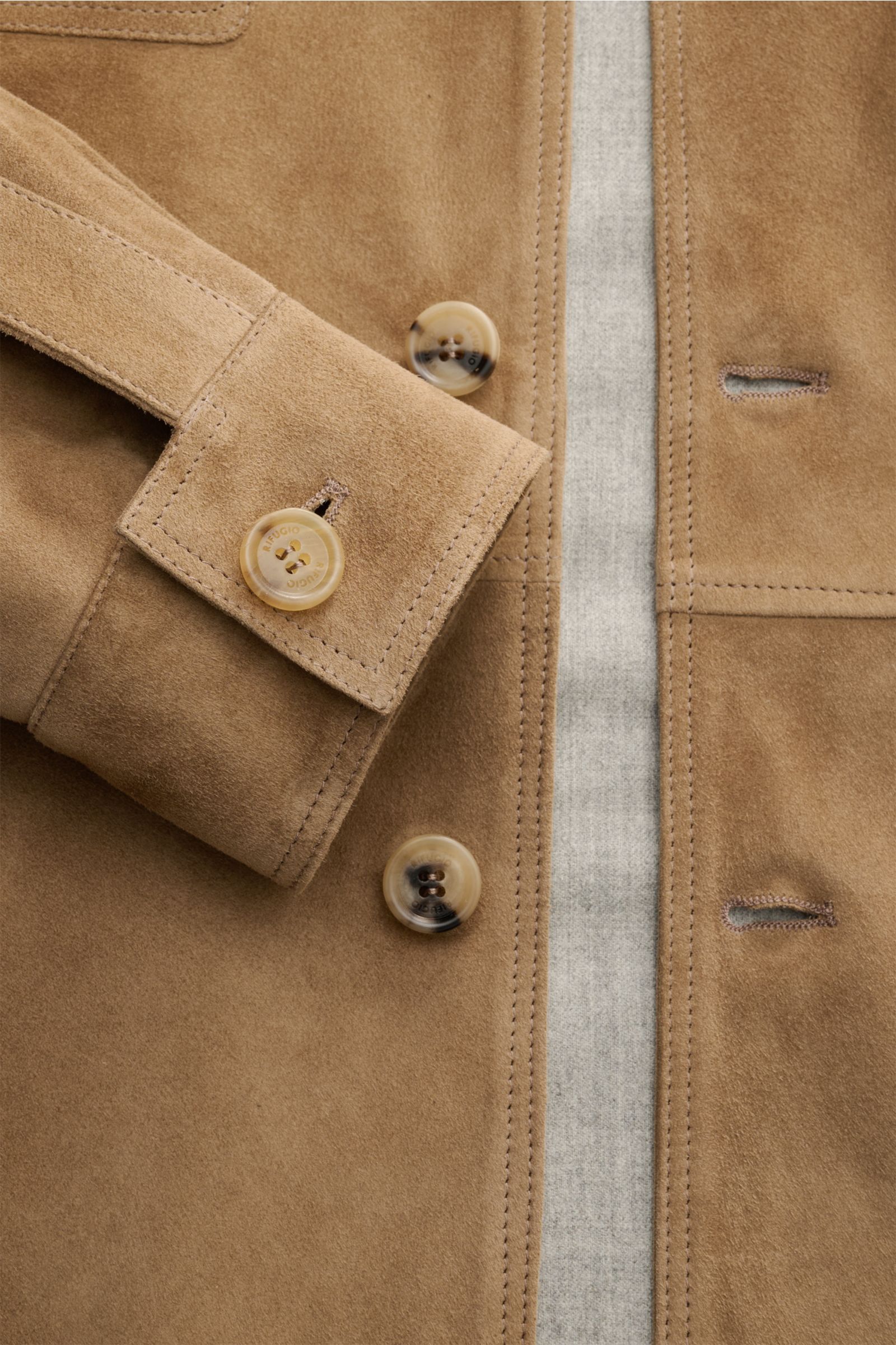 Close-up front view of Rifugio Suede jacket light brown showing smooth suede texture, slim fit, five-button placket, turn-down collar, patch breast pockets, side seam pockets, cuffed sleeves with buttons, and soft wool lining for warmth. 

Casual style