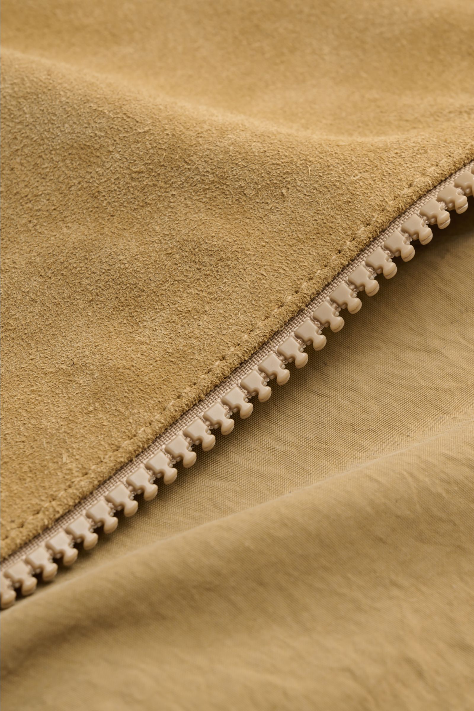 Close-up detail view of light brown suede texture and beige zipper on the Stone Island Suede jacket 'Ghost Piece' light brown.

Description: Casual statement piece with authentic leather craftsmanship: The suede jacket 'Split Leather S.I. Ghost' from t