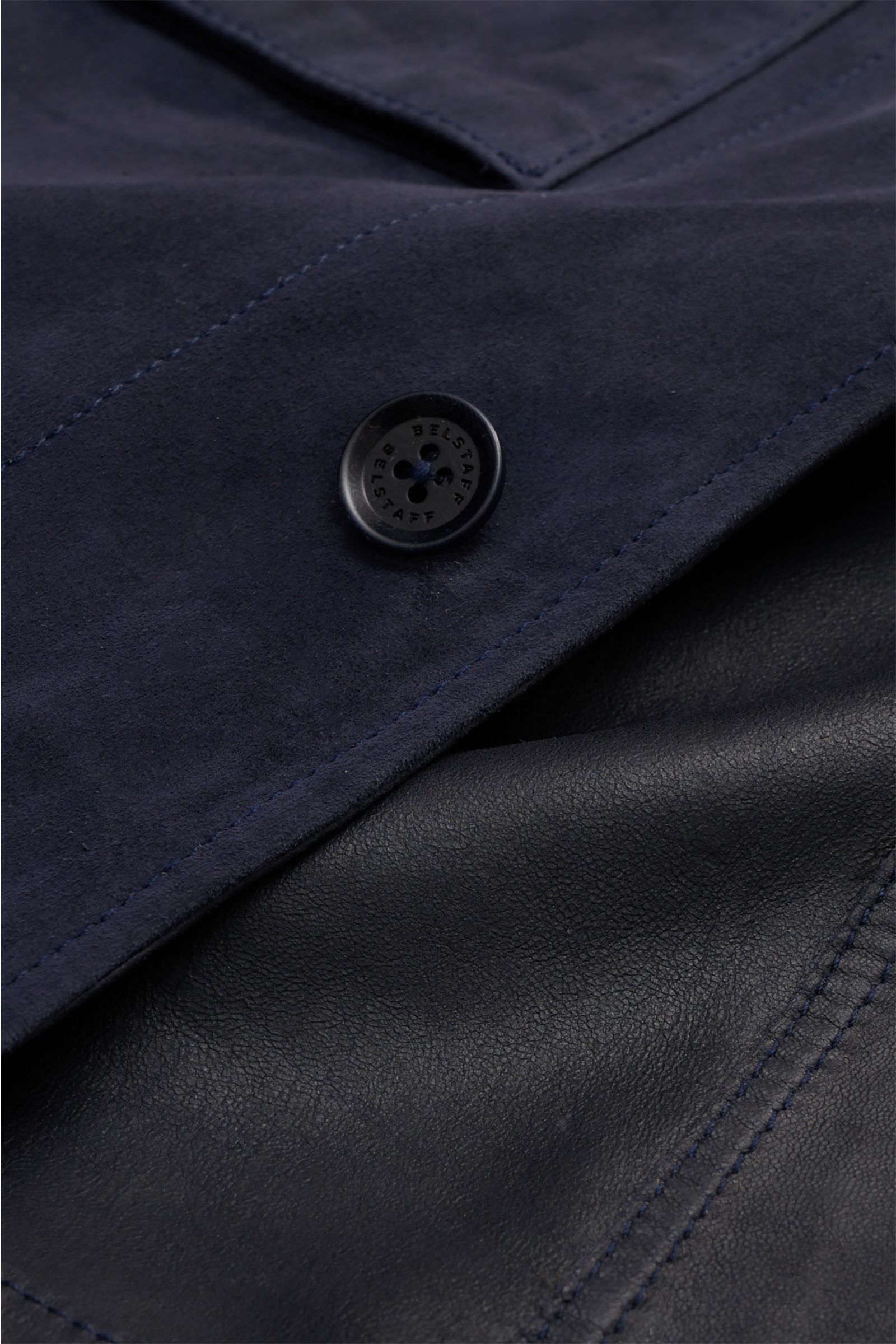 Close-up front detail of Belstaff Suede jacket 'Waymark' navy showing supple suede, button, and stitching from a top-down perspective.

A versatile piece in supple suede: The hybrid 'Waymark' by BELSTAFF is a cool alternative piece, which looks just as