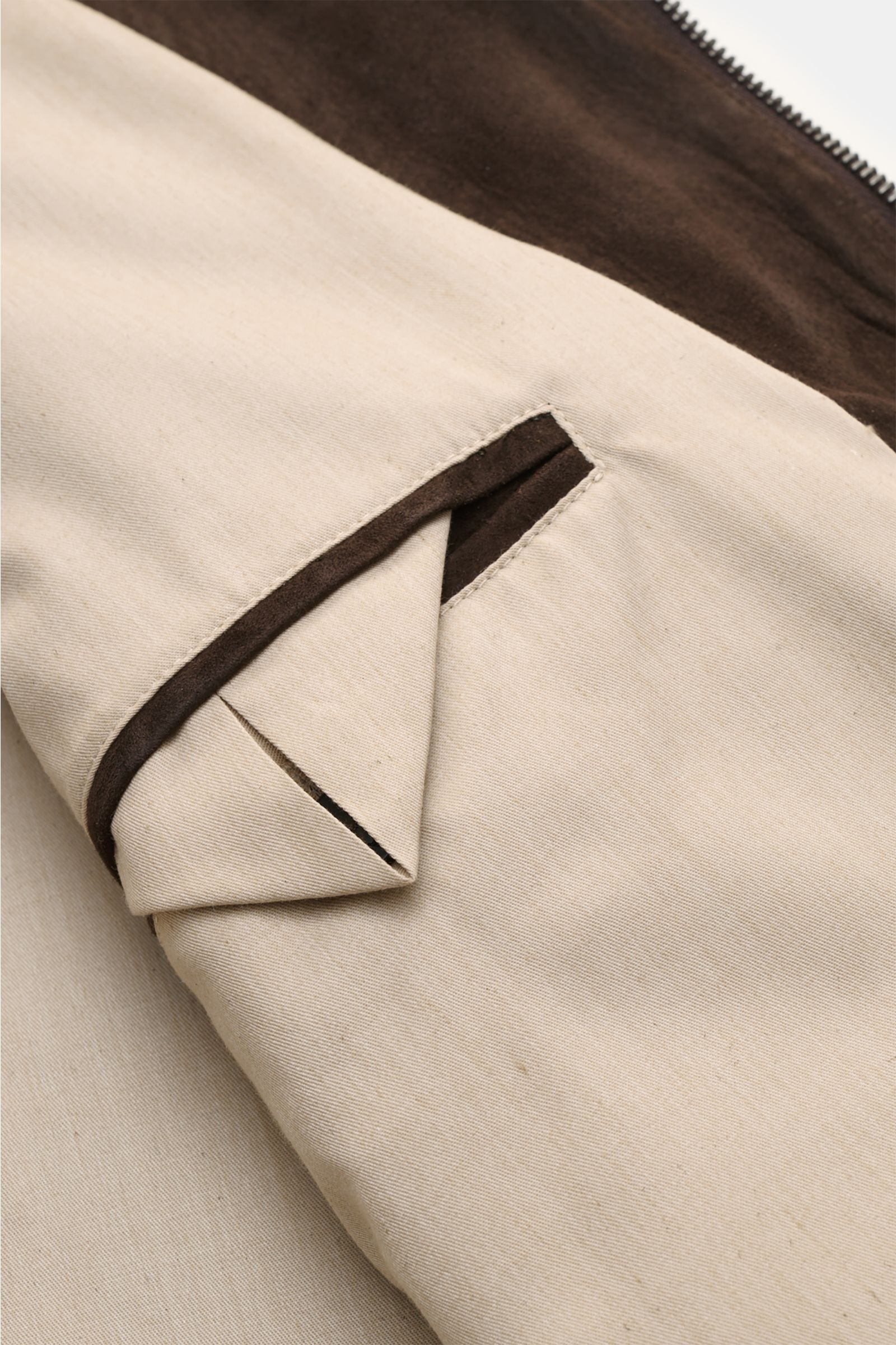 Close-up image from the inside showing the contrasting beige lining and dark brown suede trim of the Agnona Suede blouson dark brown. A blouson that combines a confident, casual air and luxurious material: This model in suede by AGNONA reinterprets the cl