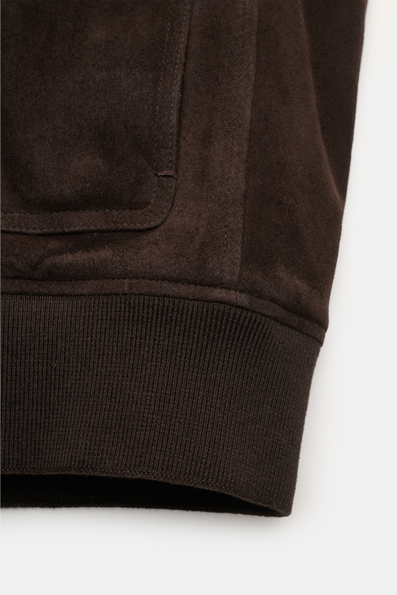 Close-up front view of Agnona Suede blouson dark brown showing premium suede texture, patch pocket, and ribbed cotton-silk band cuff.

A blouson that combines a confident, casual air and luxurious material: This model in suede by AGNONA reinterprets the c