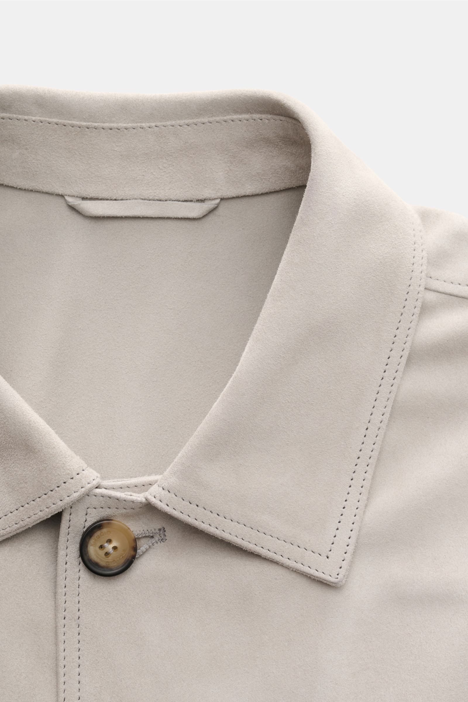 Close-up front view of Rifugio Suede jacket light grey showcasing smooth suede, soft feel, slim fit, five-button placket, turn-down collar, patch front pockets with flap, sleeves with cuffs, unconstructed design, and two inside pockets, highlighting confi