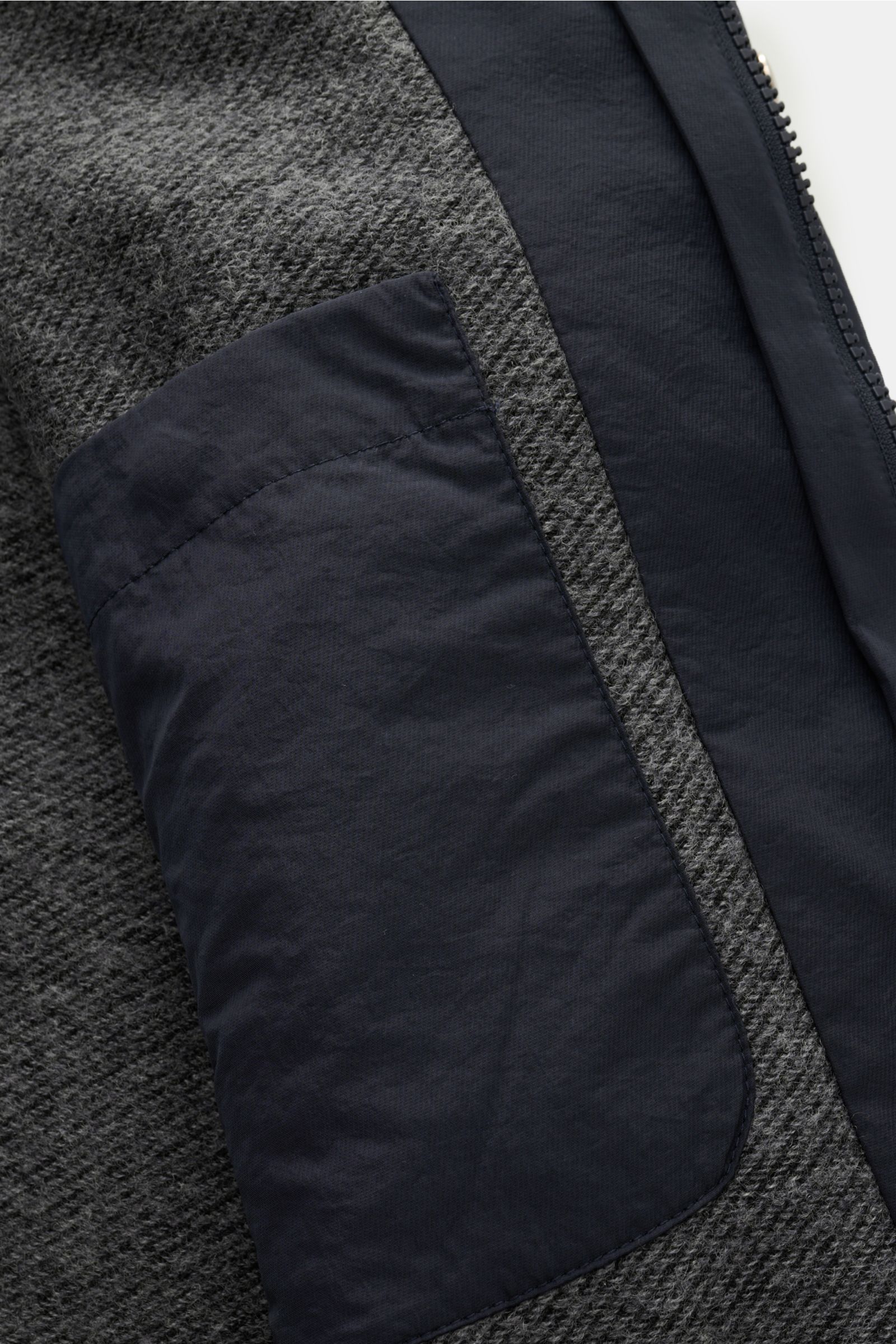 Close-up interior view of the 04651/ A trip in a bag Parka 'The Triple' navy showing the contrasting lining and inside pocket, lightweight microfiber with a slightly textured feel.