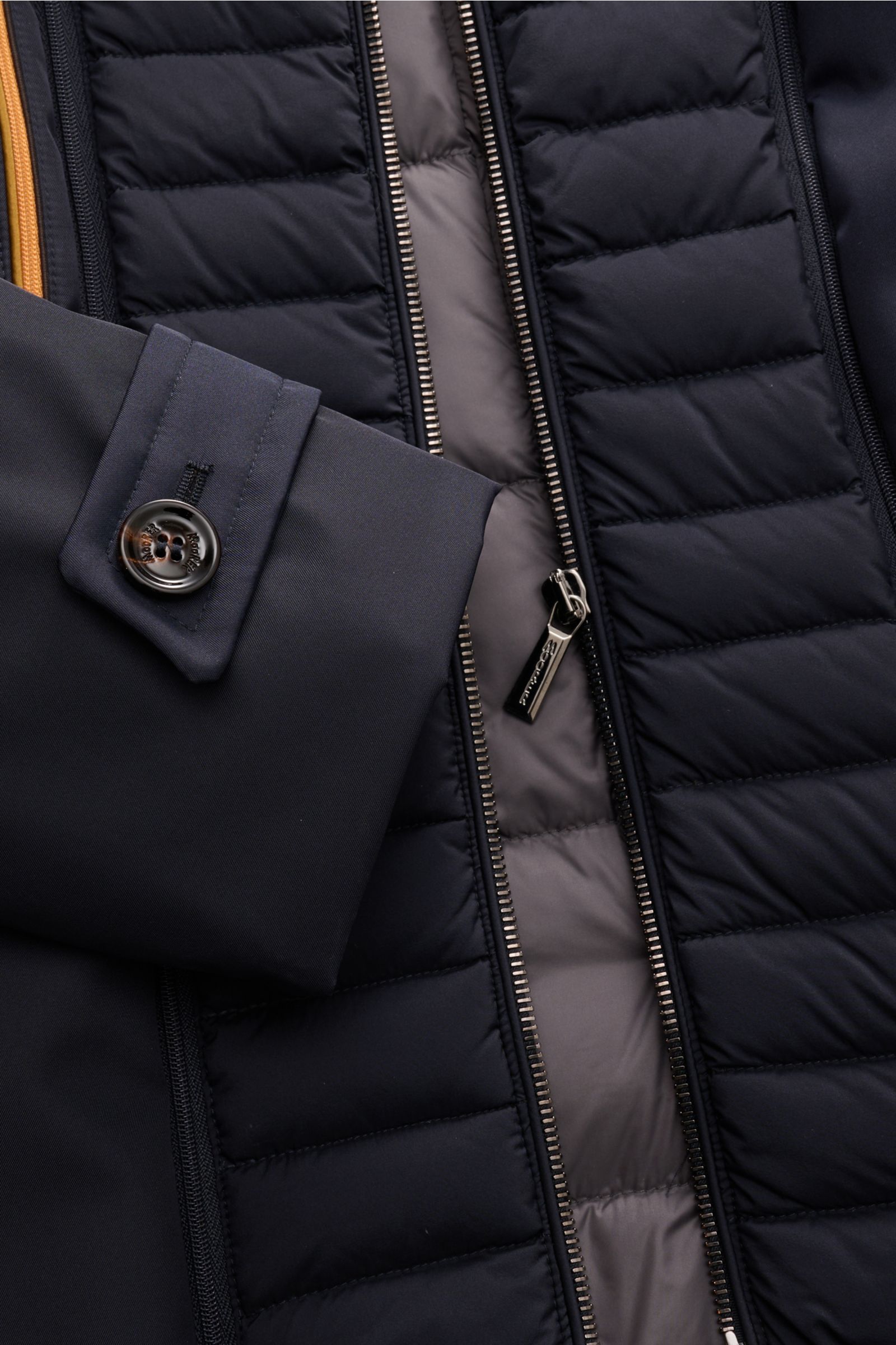 Close-up front view of Moorer Daunenjacke 'Bolgi' navy showing buttoned sleeve cuff, double front zipper, and quilted down filling.