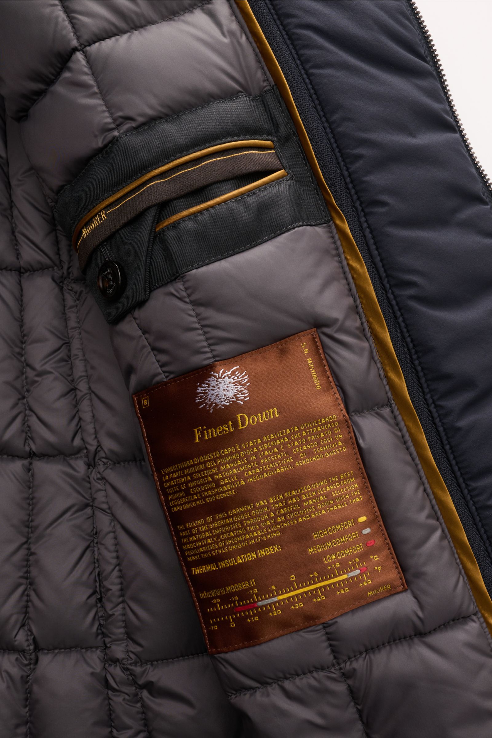 Close-up inside view of the Moorer Daunenjacke 'Bolgi' navy showing quilted lining, inner pocket, and Finest Down label with thermal insulation details.