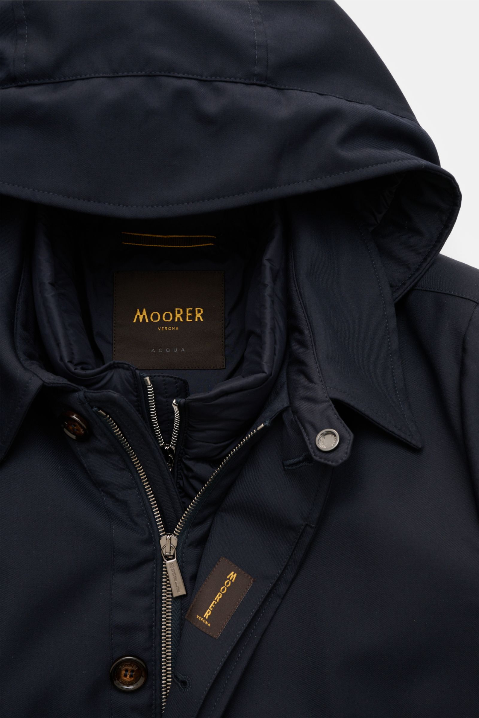 Close-up front view of the Moorer Jacke 'Elson' navy, showing the hood, two-way zipper, and soft microfiber and viscose mix fabric with a removable down jacket inside for versatile cold weather wear.