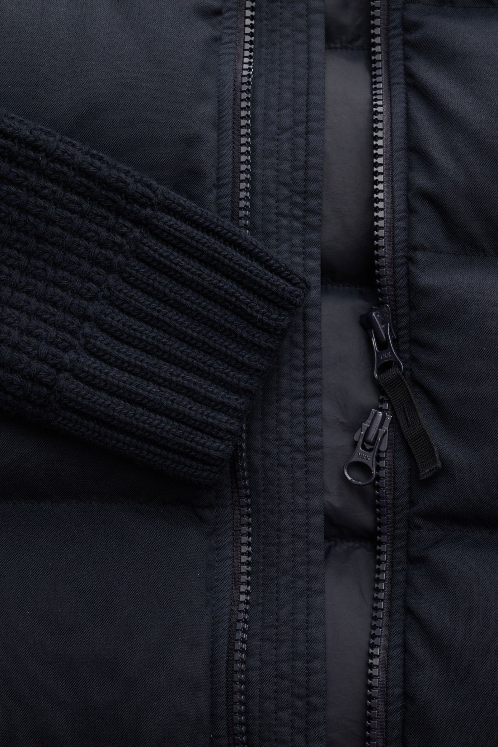 Close-up front view of the Stone Island Daunenjacke 'Twill Wool-TC Ghost Piece' navy, showcasing the garment-dyed twill wool fabric, knit sleeves, robust two-way zipper, and soft padded down filling. Monochromes Statement-Piece für die Übergangszeit: Die 