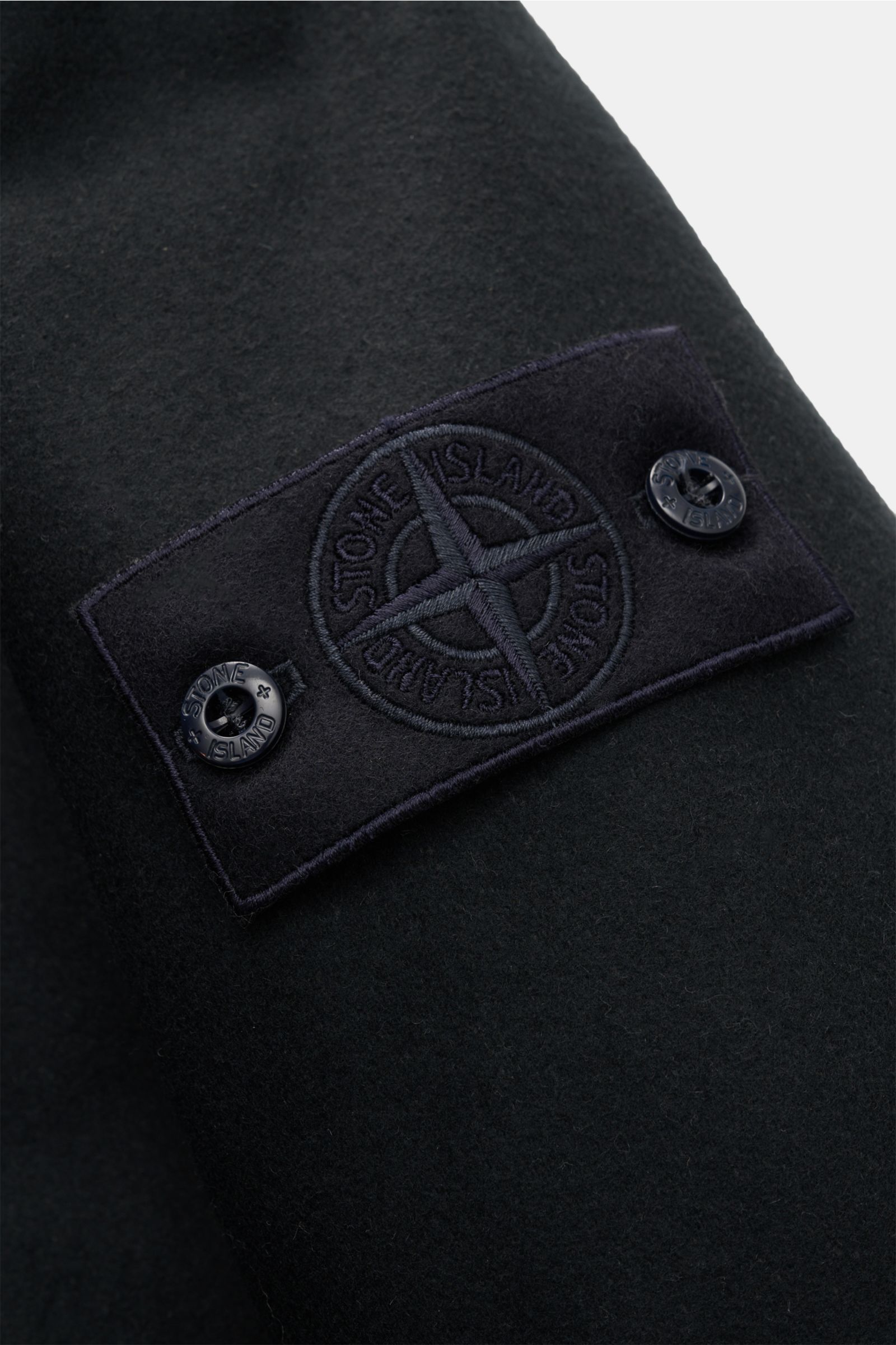 Close-up front-side perspective of the Stone Island Jacke 'Wool Nylon Flannel Ghost Piece' navy showing the tonal compass badge on water-repellent wool-nylon flannel fabric.