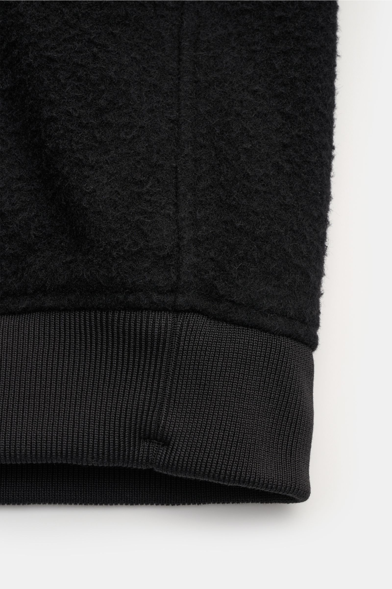 Close-up front view of the Stone Island Blouson 'Panno Ratinato' schwarz showing textured wool-mix fabric and ribbed elastic hem detail.