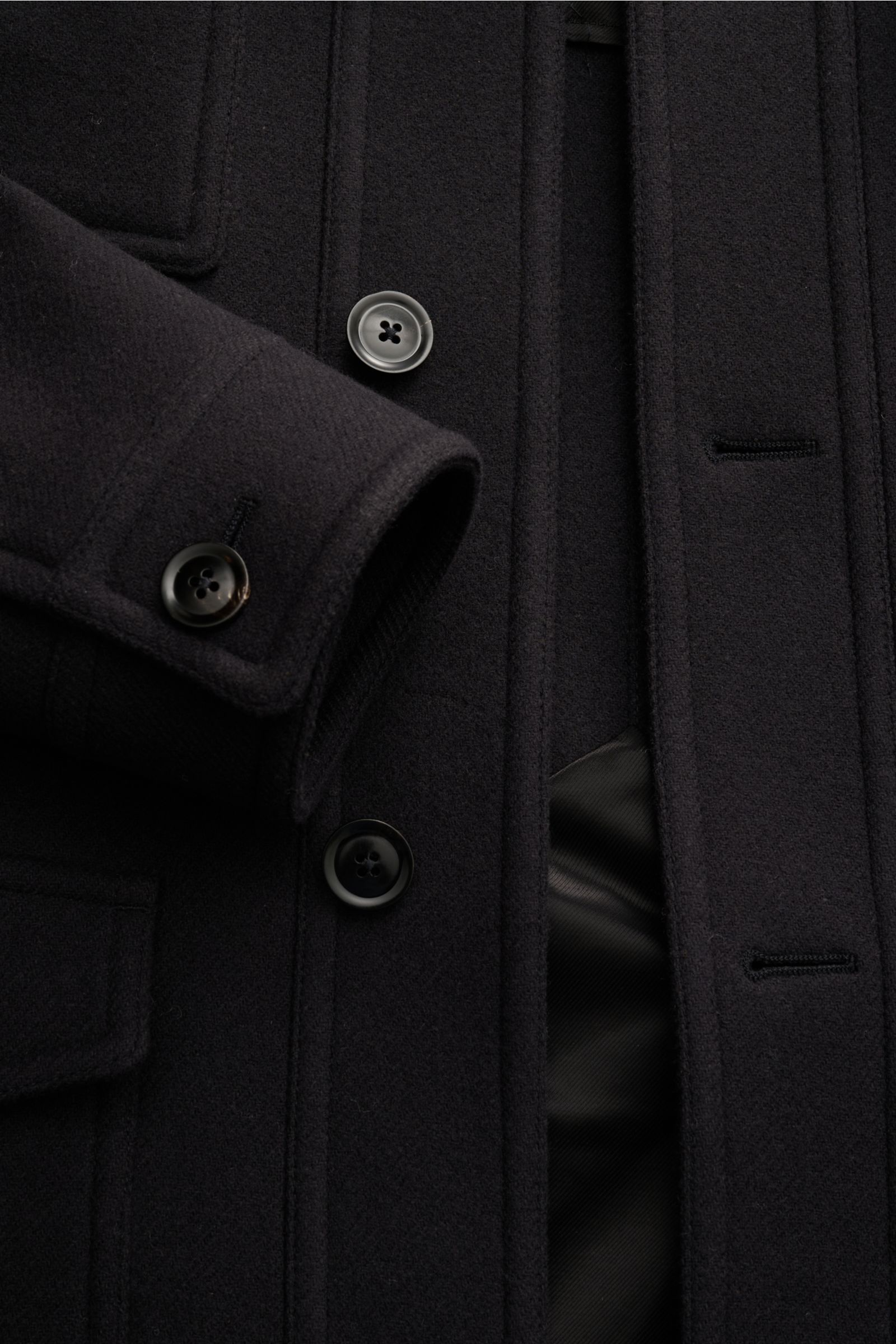 Close-up front view of Tom Ford Wool jacket navy showing clean lines, button placket, flap pockets, and cuff details in soft virgin wool.

With its clean lines and distinctive flap pockets, this wool jacket by TOM FORD combines timeless utility element