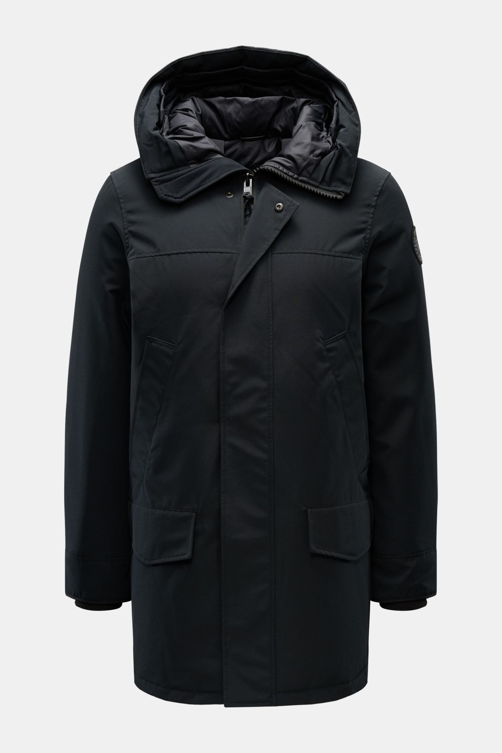 Canada Goose Down parka 'Langford' black shown from the front with hood up, featuring Arctic-Tech material, warm down lining, two-way zip, storm flap with snap buttons, high-collar hood, internal rucksack straps, hand-warmer and hip pockets, tonal sleeve 