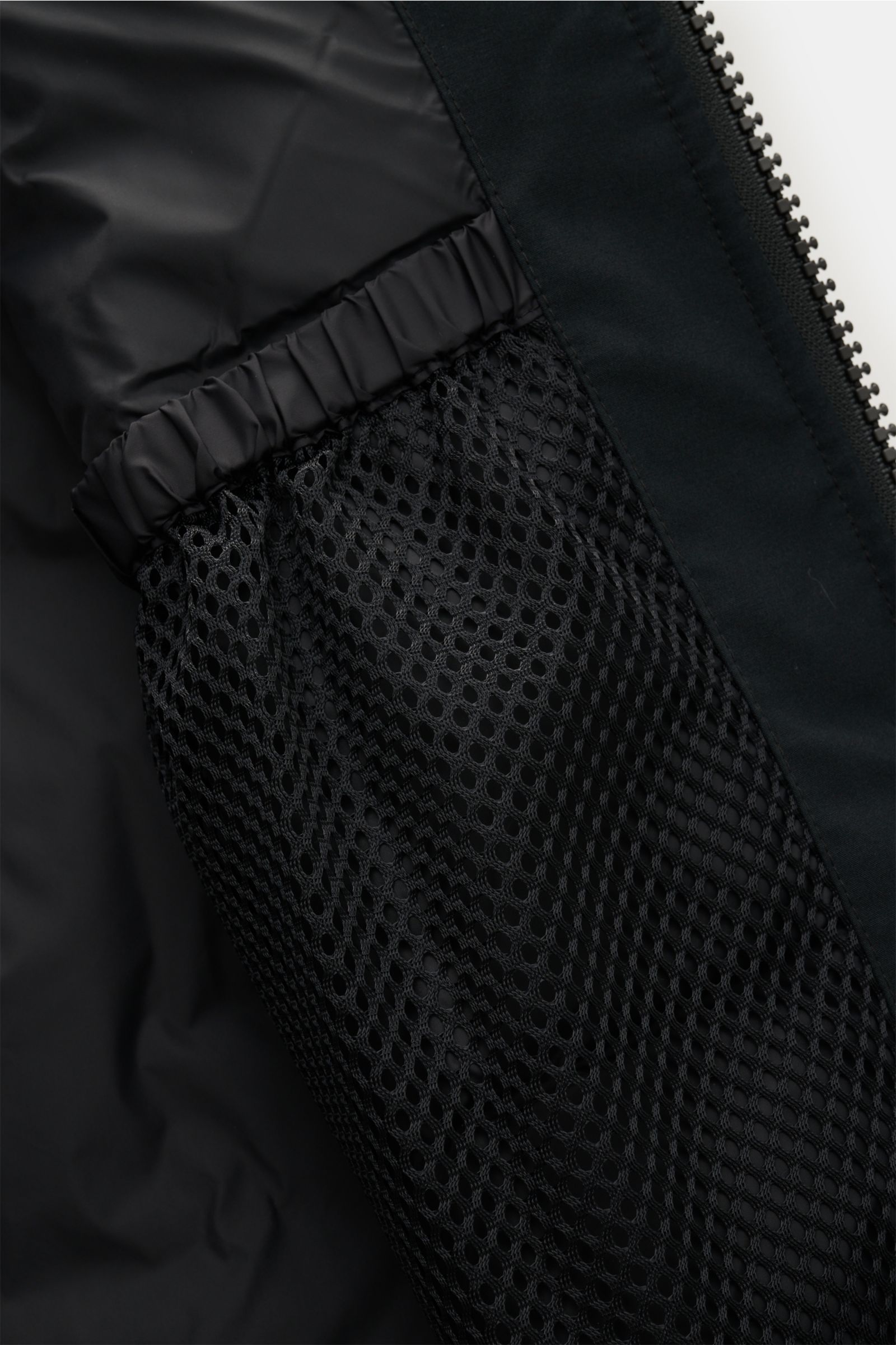 Close-up interior view of the Canada Goose Down parka 'Langford' black showing the mesh pocket, elastic band, and zipper detail.

Description: Urban style with an arctic background – the down parka 'Langford' by CANADA GOOSE impresses with its clear, f