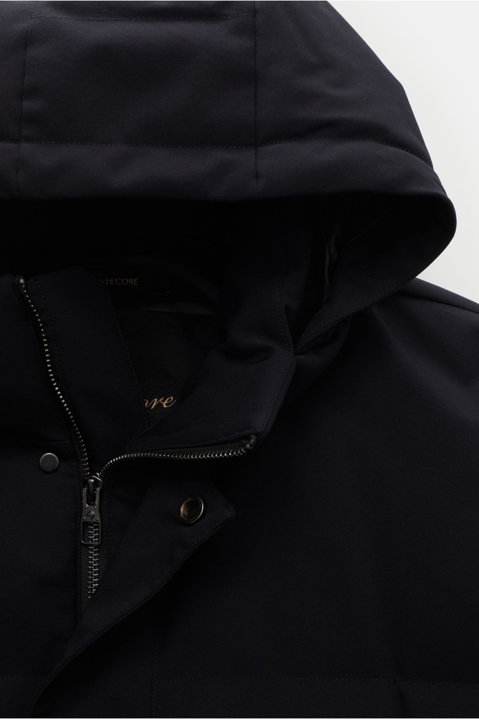 Close-up front view of the Montecore Down coat dark navy, showing high fastening collar with detachable hood, robust two-way zip, and storm flap with snap buttons. High-quality microfibre, slightly robust to the touch, wind and water repellent, breathable