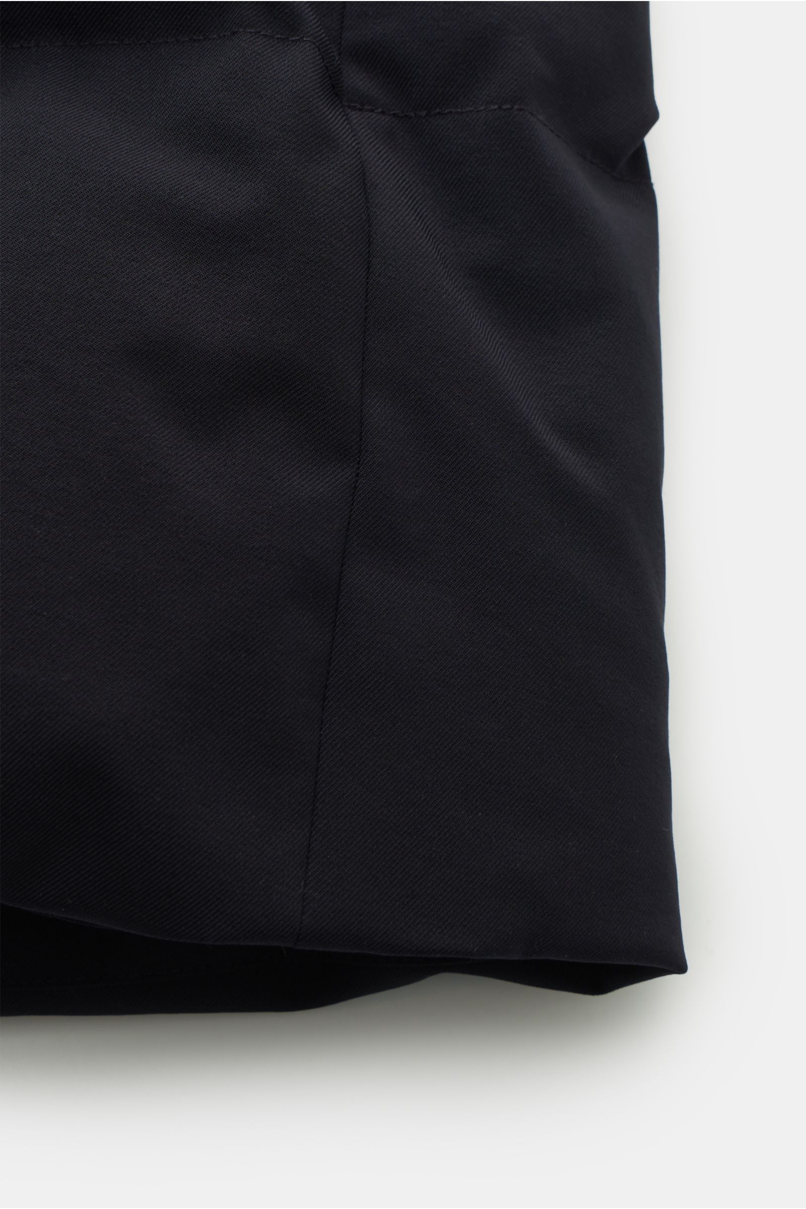 Close-up side view of the Montecore Down coat dark navy showing high-quality microfibre fabric, slightly robust to the touch, wind and water repellent, breathable, with duck down lining, regular fit, robust two-way zip, storm flap with snap buttons, high 