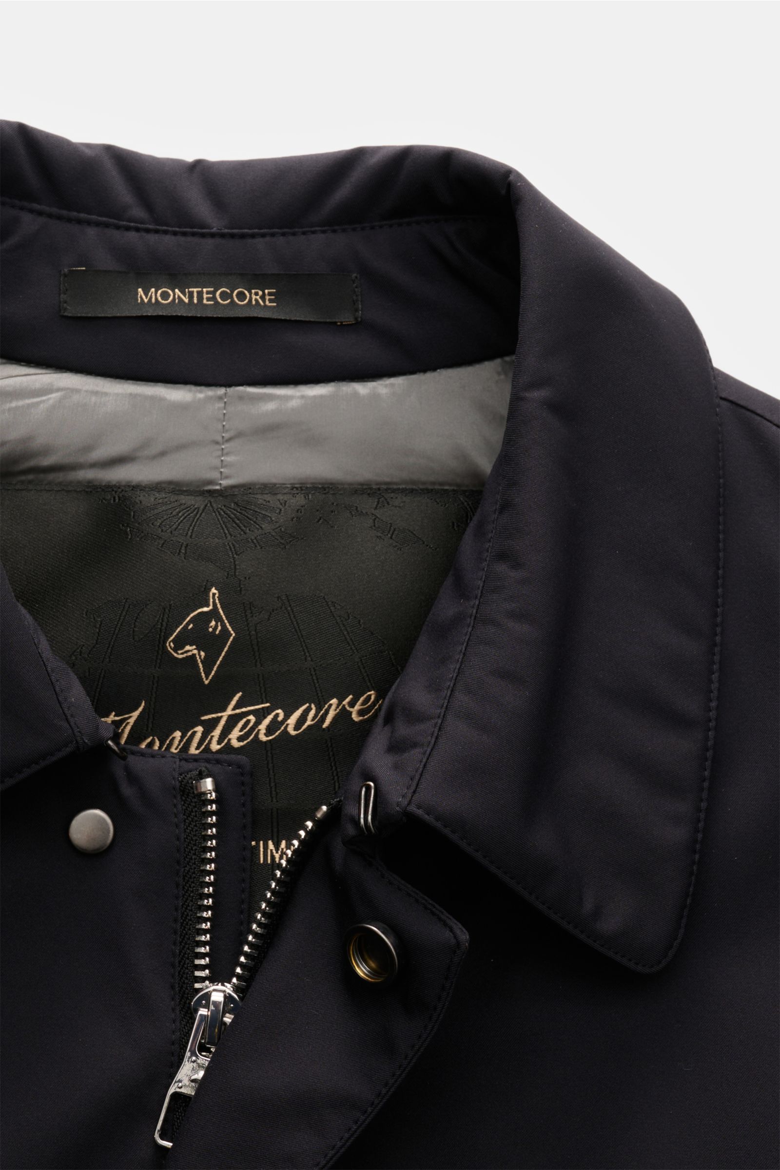 Close-up front view of the Montecore Daunenjacke navy, showing collar, zipper, snap button, and inner lining with logo, made of high-quality microfiber, smooth touch, light down filling, slim fit, two-way zipper, wind flap with buttons, turn-down collar, 