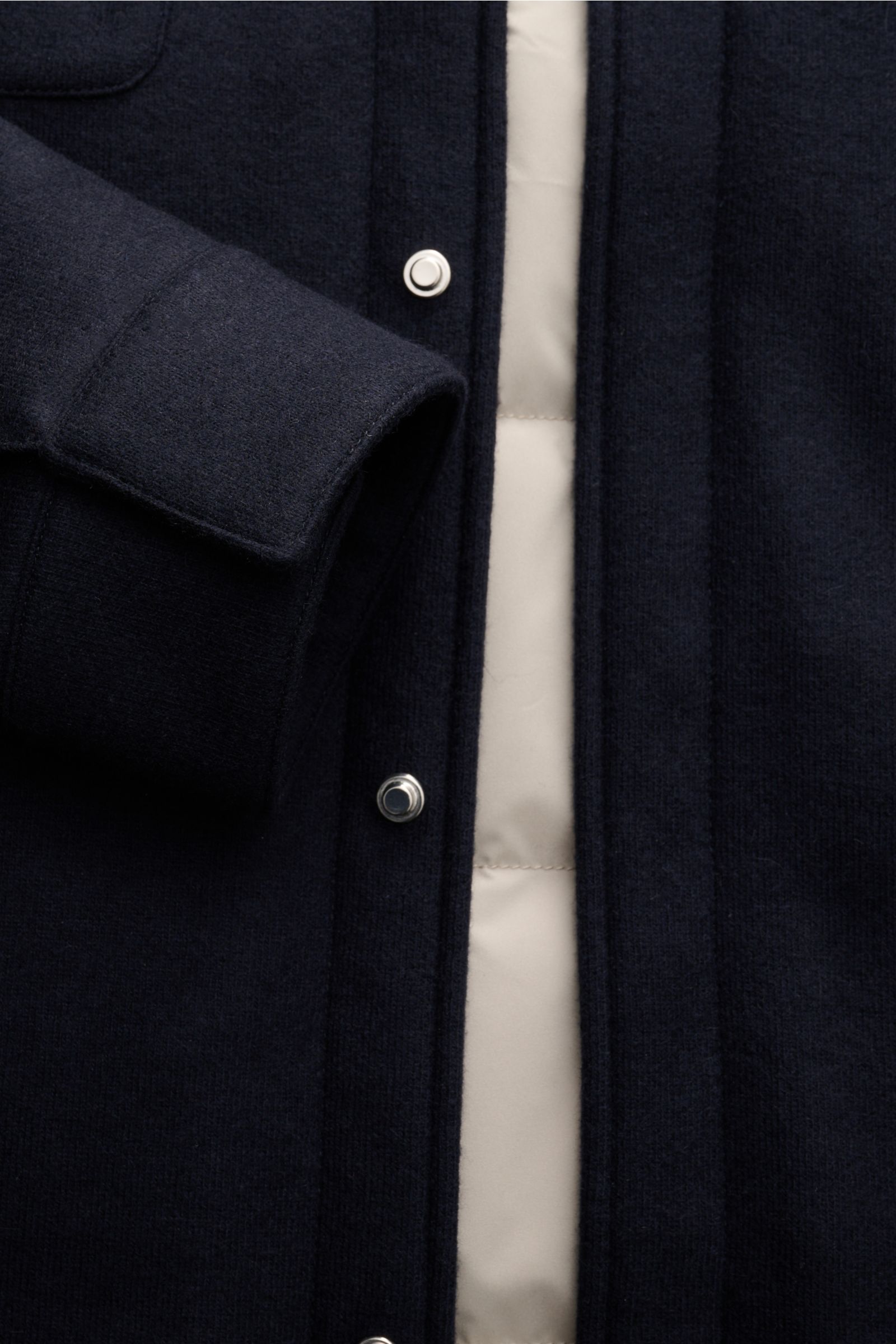 Close-up front view of the Mandelli Cashmere Daunenjacke navy showing the soft cashmere sleeve cuff, six-button placket, and light down filling.