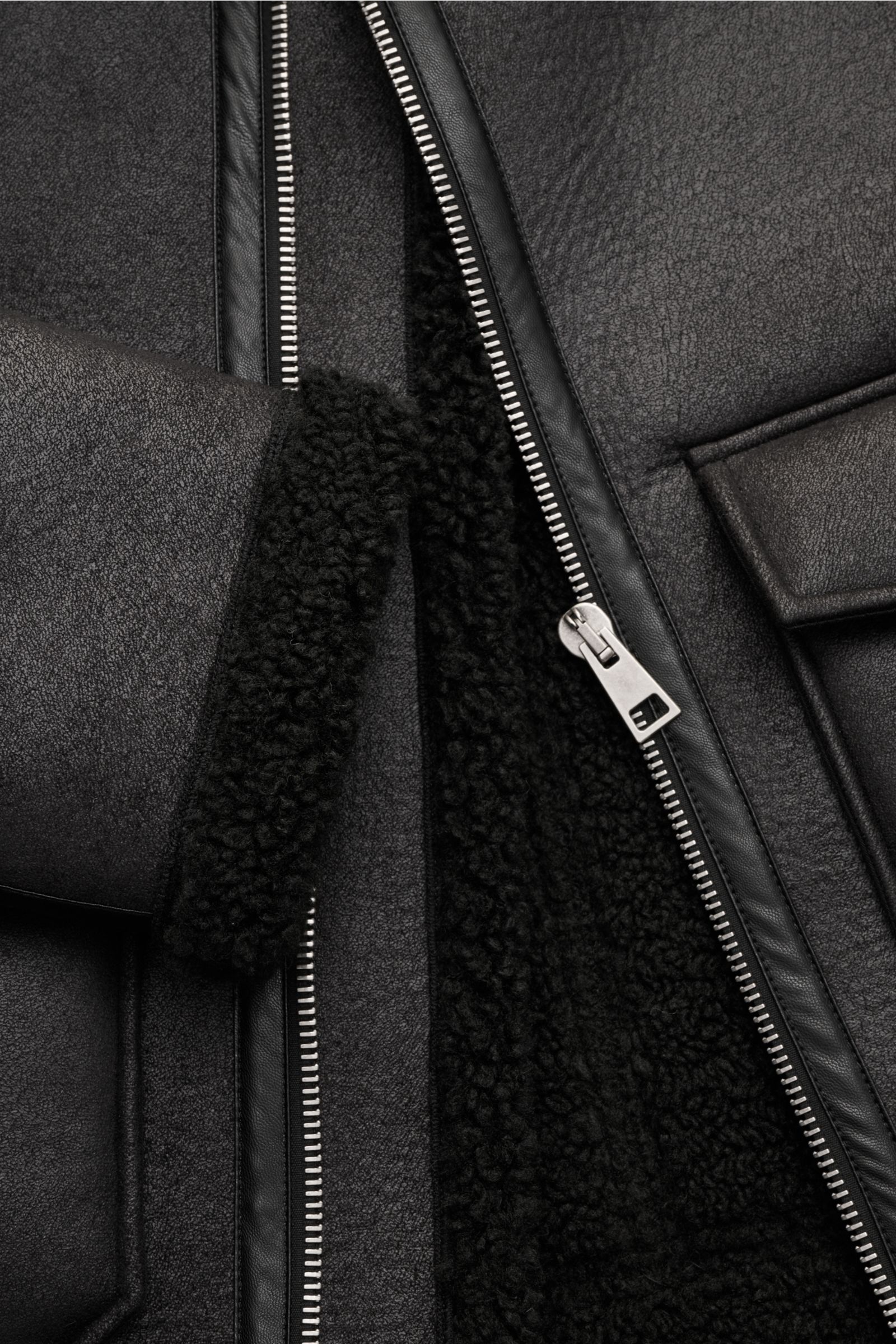 Nahaufnahme der A.P.C. Jacke 'Tommy' schwarz aus Slim Fit Microfaser mit weichem Griff, Metall-Reißverschluss, breitem Umlegekragen und aufgesetzter Fronttasche.