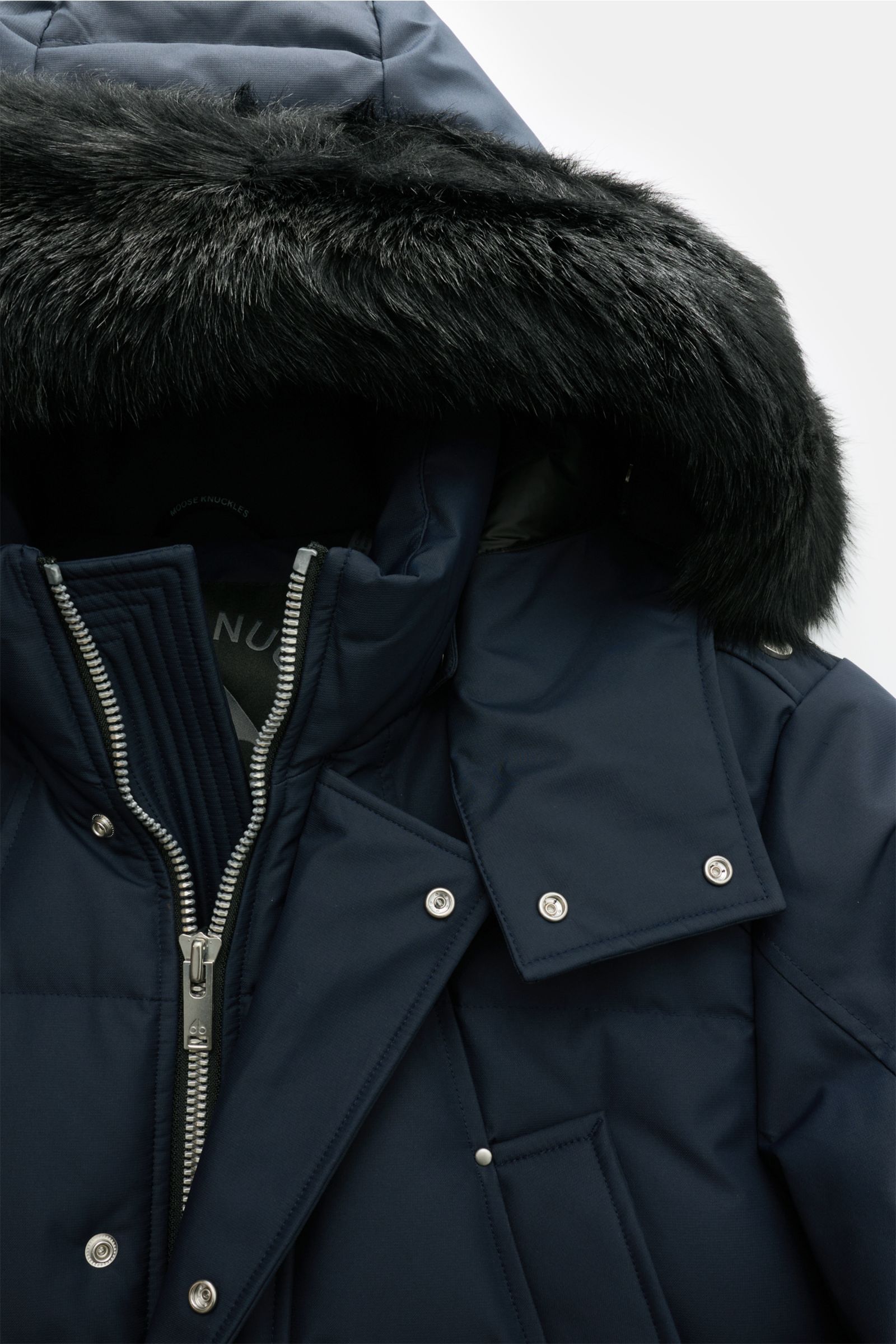 Close-up front view of Moose Knuckles Down parka 'Cloud parka Neoshear' navy, showing detachable black shearling hood trim, silver two-way zip, snap buttons, high collar, and smooth, high-quality, water-repellent microfiber fabric. With the 'Cloud' series