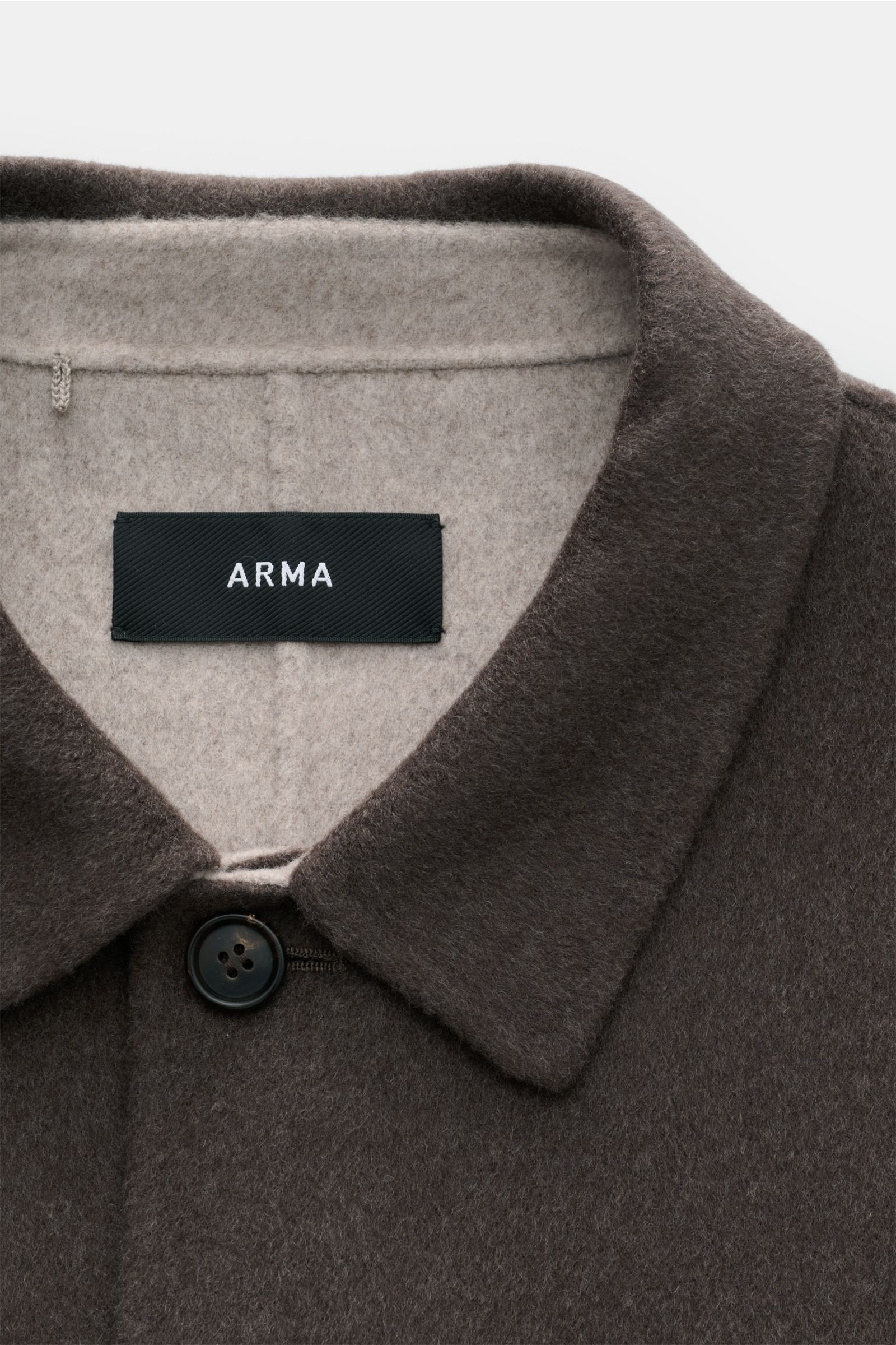 Close-up front view of the Arma Overshirt 'Navid' grey-brown showing the turn-down collar, single button, and ARMA label inside. A contemporary update for your casual wardrobe: The overshirt 'Navid' by ARMA has a boxy silhouette and a fine double-face fin