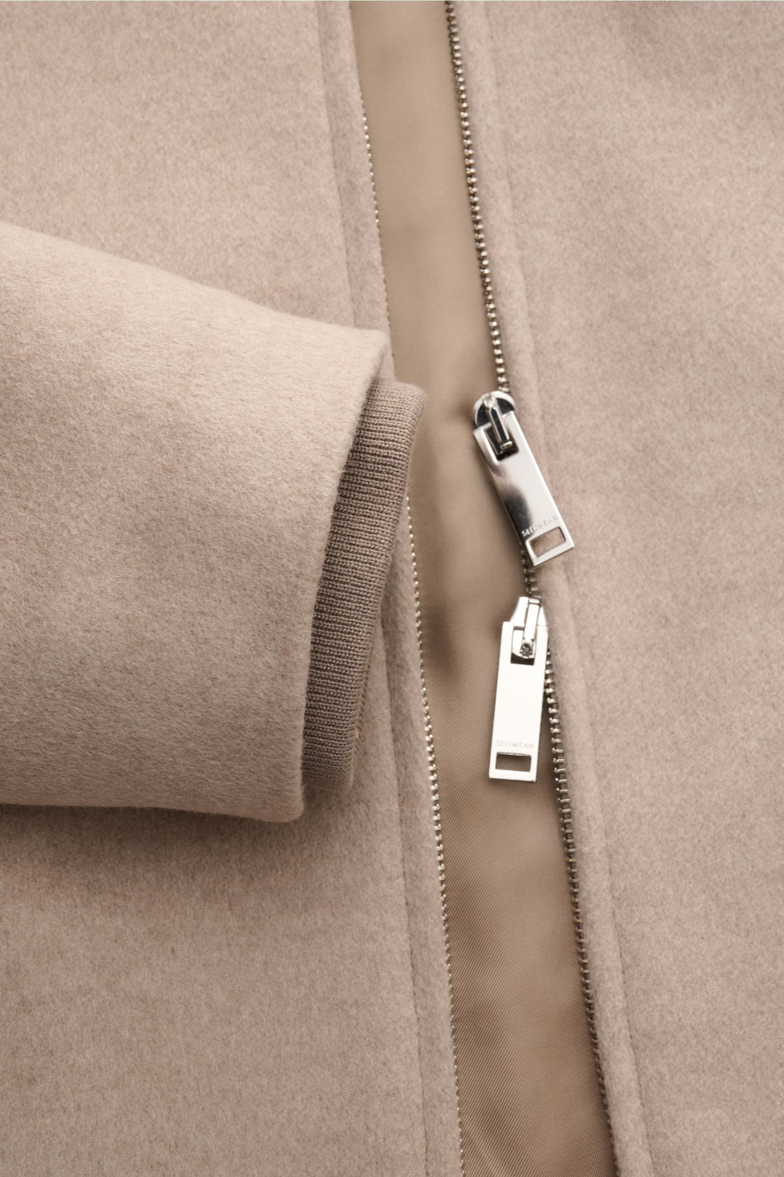Close-up front view of Montedoro Blouson beige showing soft wool fabric, two-way zipper, and ribbed cuff for comfort and style.