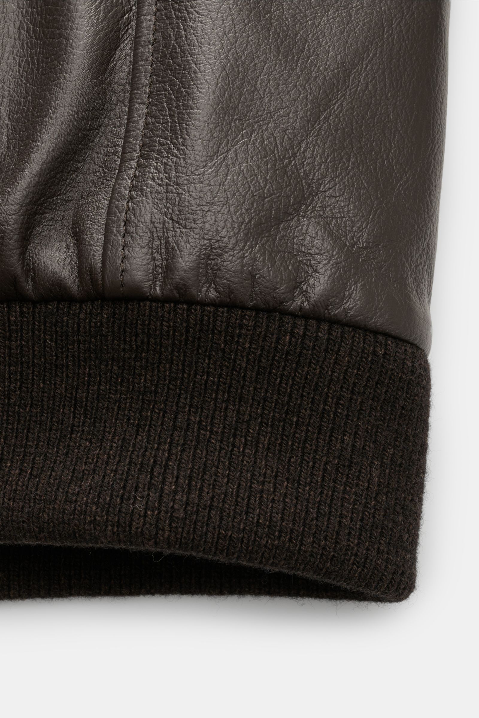 Close-up view of the ribbed hem detail on the Moorer Down leather blouson 'Cleros' dark brown, showing smooth deerskin and soft knit fabric.