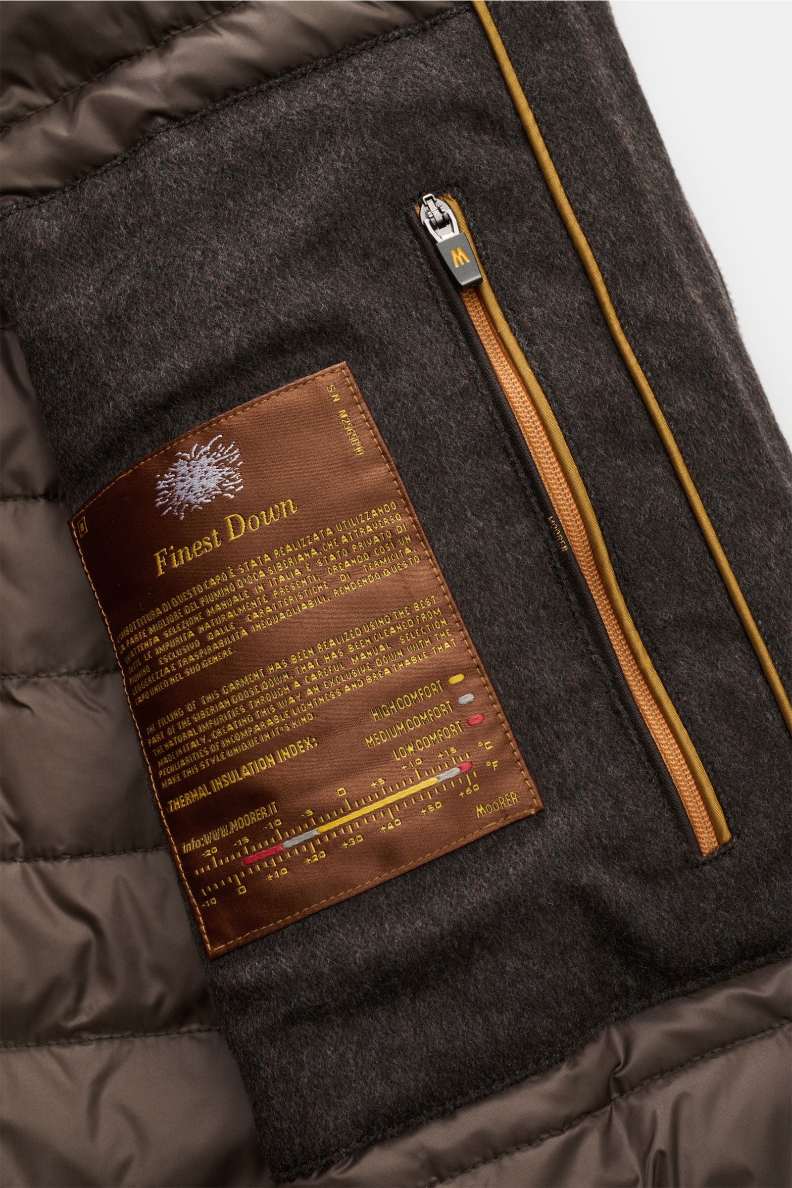 Close-up interior view of the Moorer Down leather blouson 'Cleros' dark brown showing quilted lining, Finest Down label, and zip pocket.