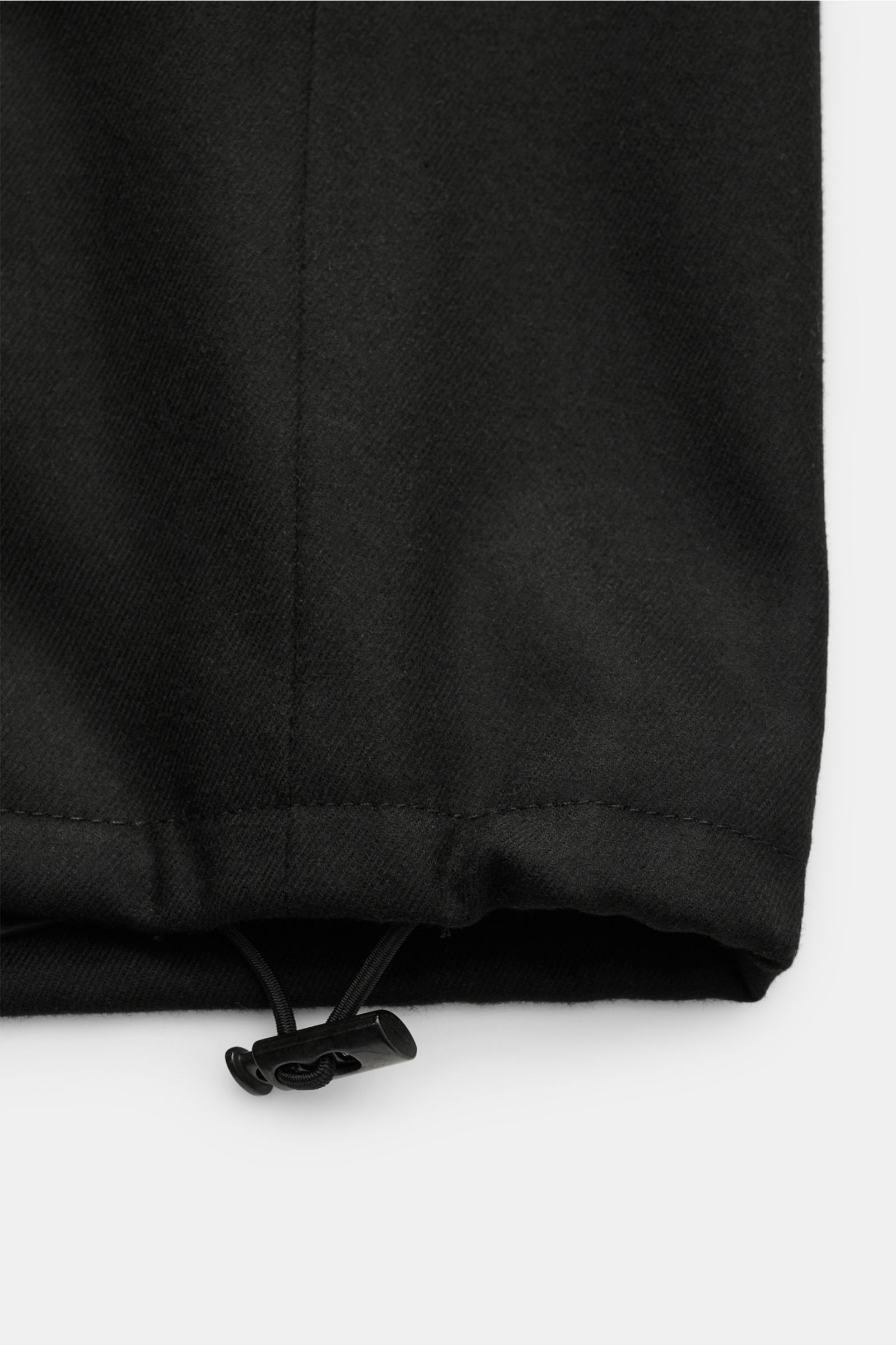 Close-up front view of the hem with adjustable drawstring of the Kiefermann Jacke 'Josepp' schwarz, made of viscose and microfiber blend with light stretch, fine twill texture, soft touch, very lightweight quality, slim fit, sturdy zipper, high stand coll